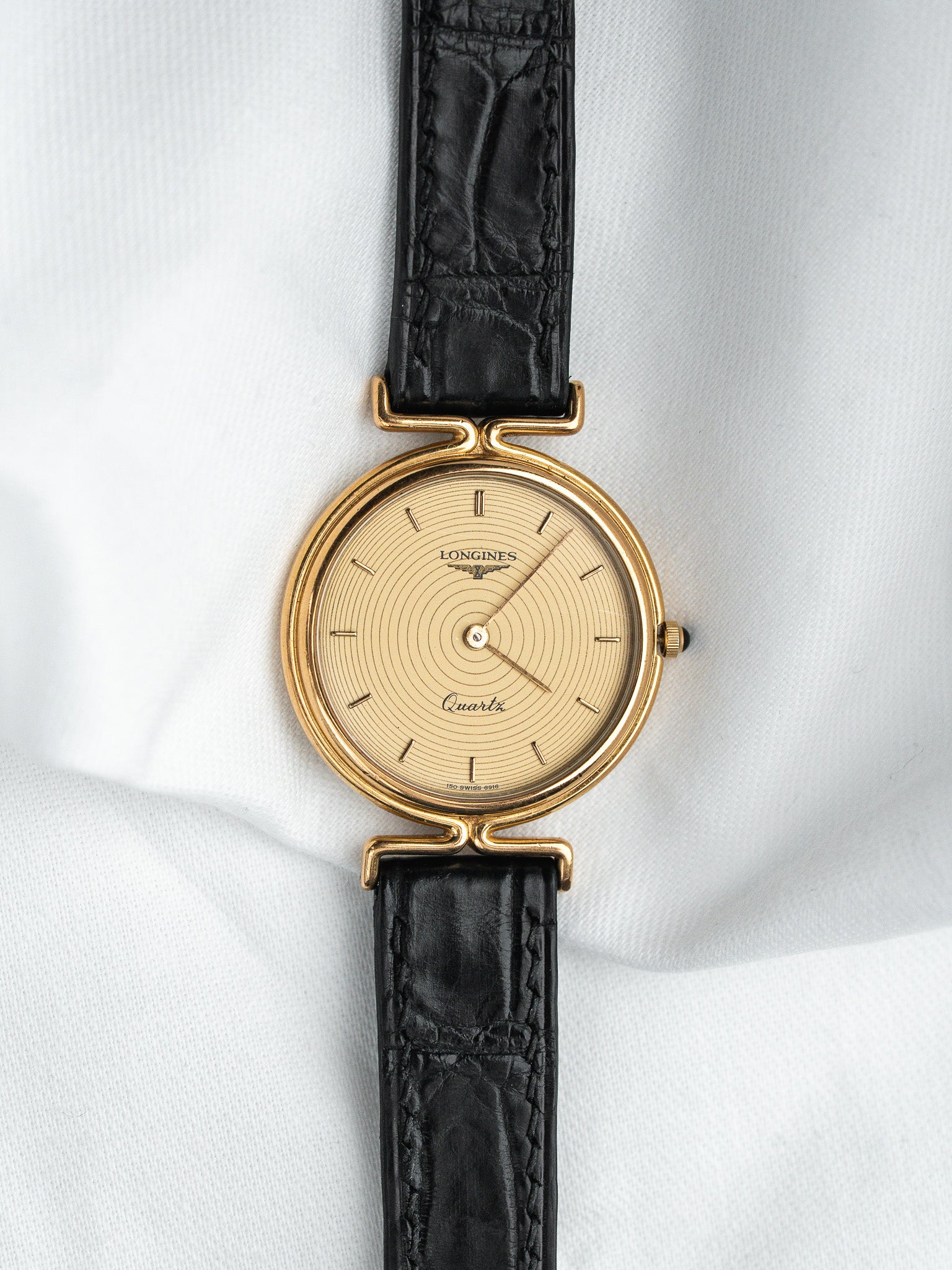 Longines Quartz vintage watch with gold case, cream dial, black leather strap
