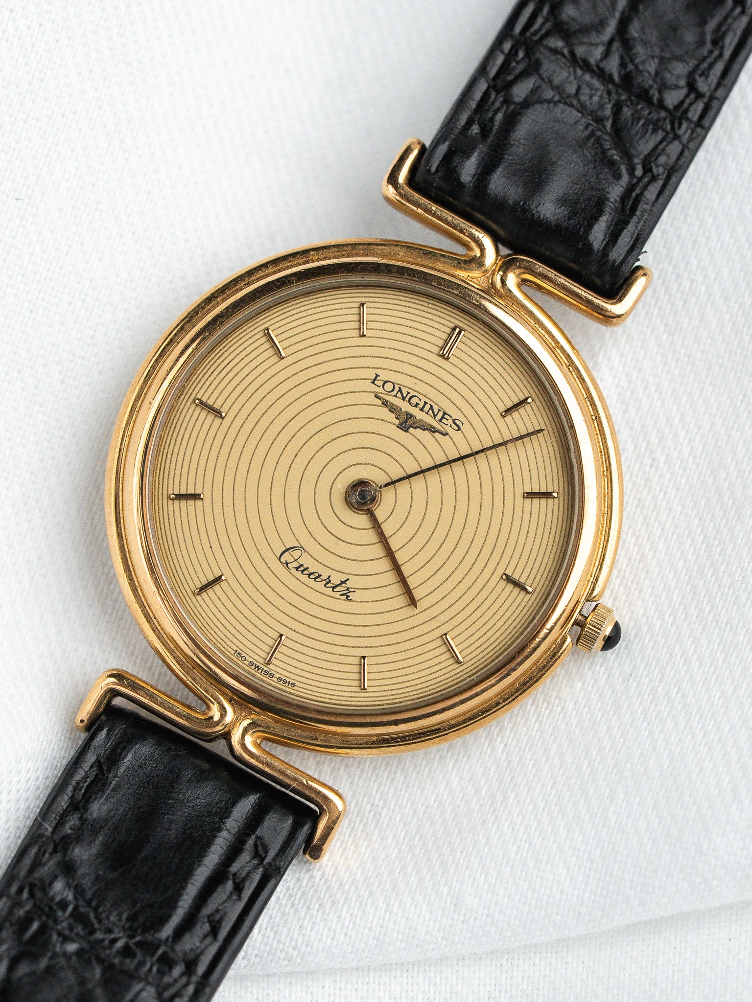 Longines Quartz vintage watch with gold case, cream dial, black leather strap
