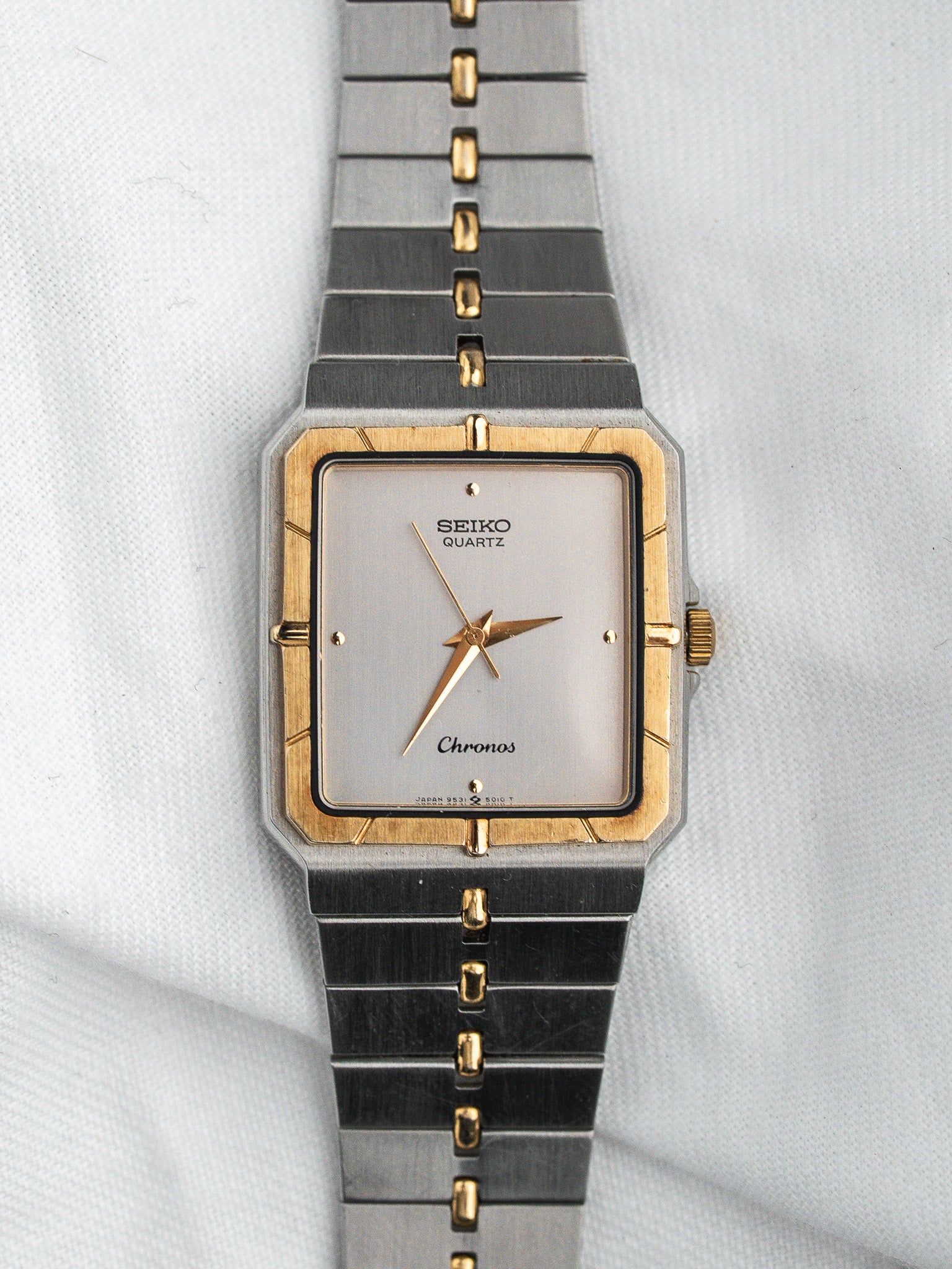 Seiko Chronos vintage quartz watch with silver dial, gold accents, and two-tone bracelet