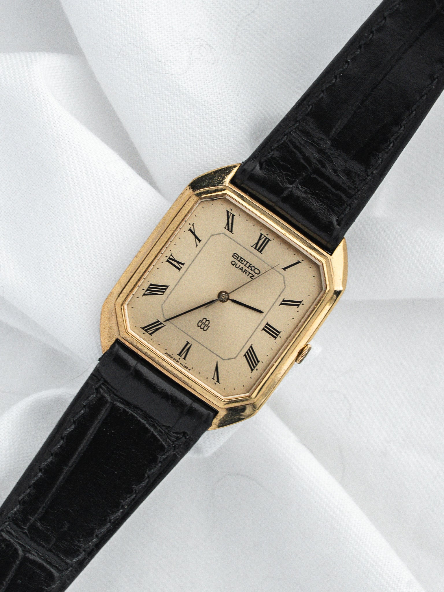 Seiko Quartz vintage watch with gold case, cream dial, Roman numerals, black leather strap