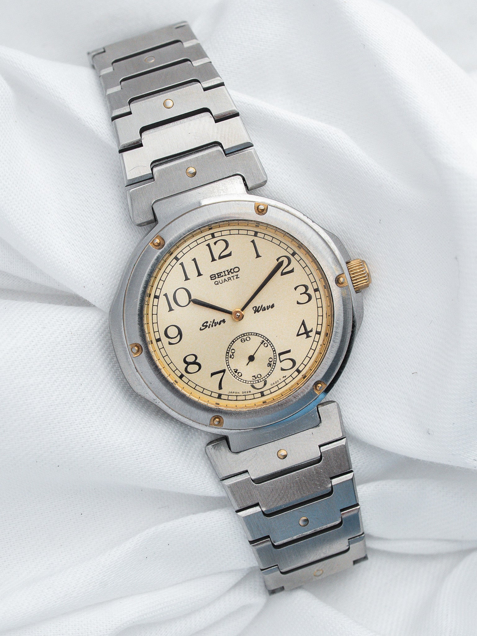 Seiko Quartz vintage watch with cream dial, steel bracelet, and gold accents