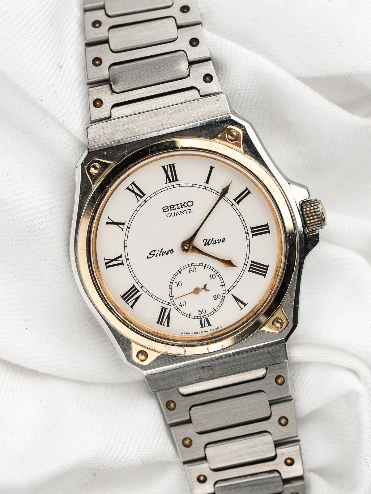 Vintage Seiko Silver Wave Watch in steel, white dial and Roman numerals, white background