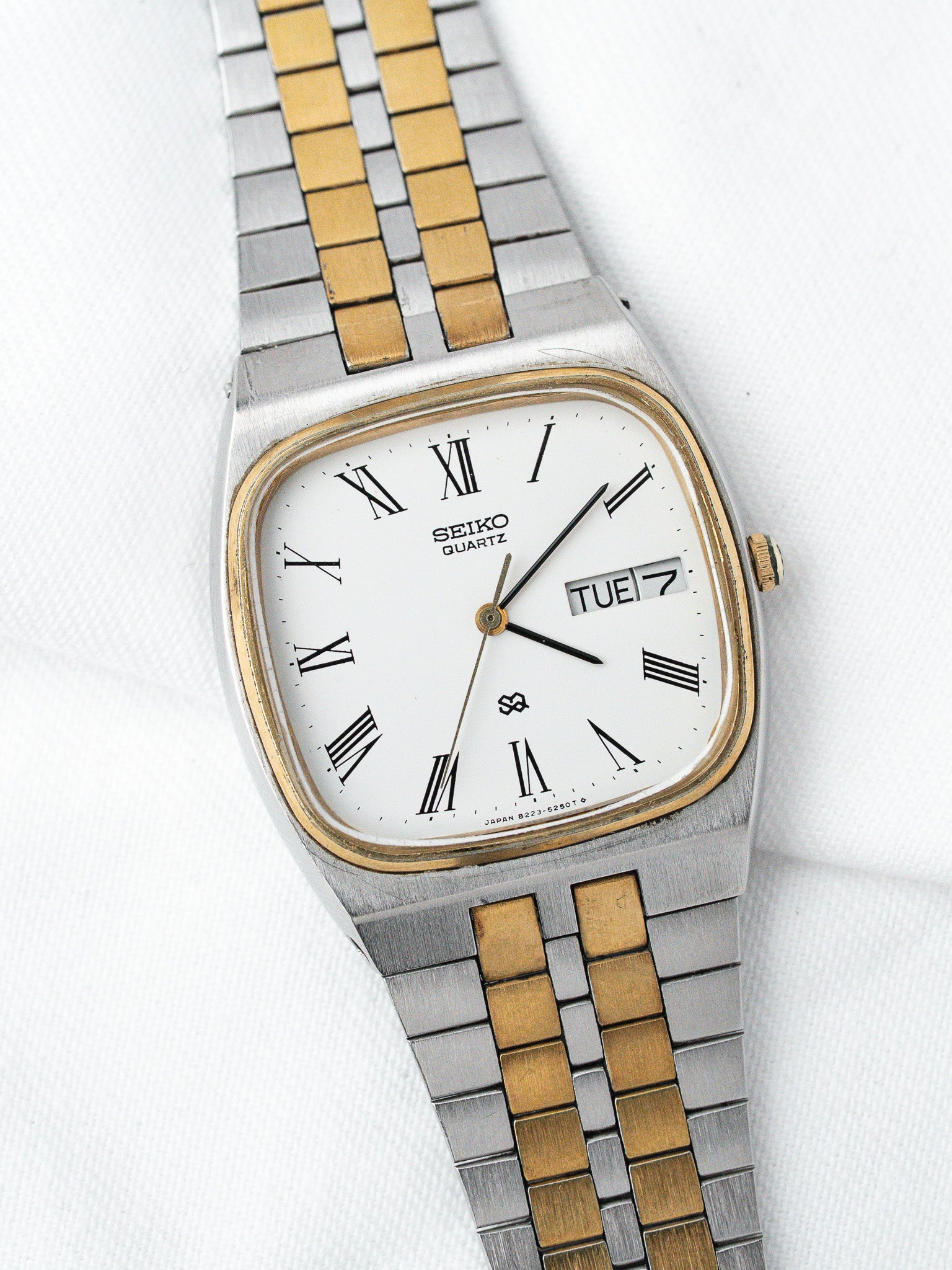 Seiko Quartz vintage watch with white dial, Roman numerals, two-tone steel and gold bracelet