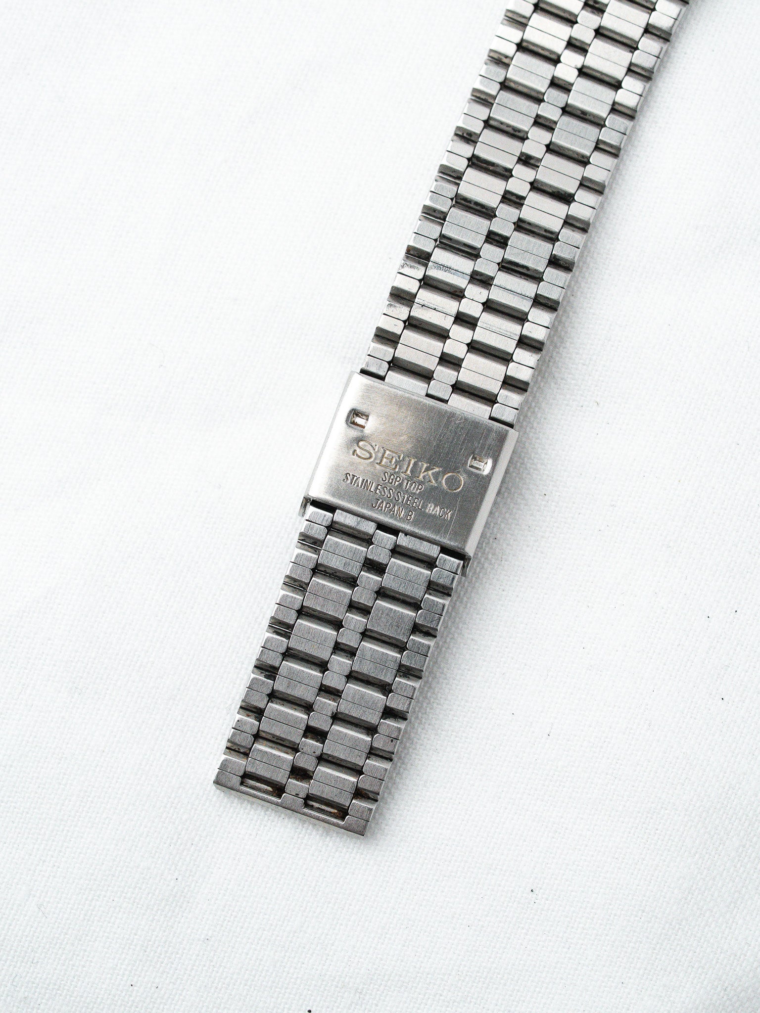 Seiko vintage stainless steel watch back with engraved logo on white background