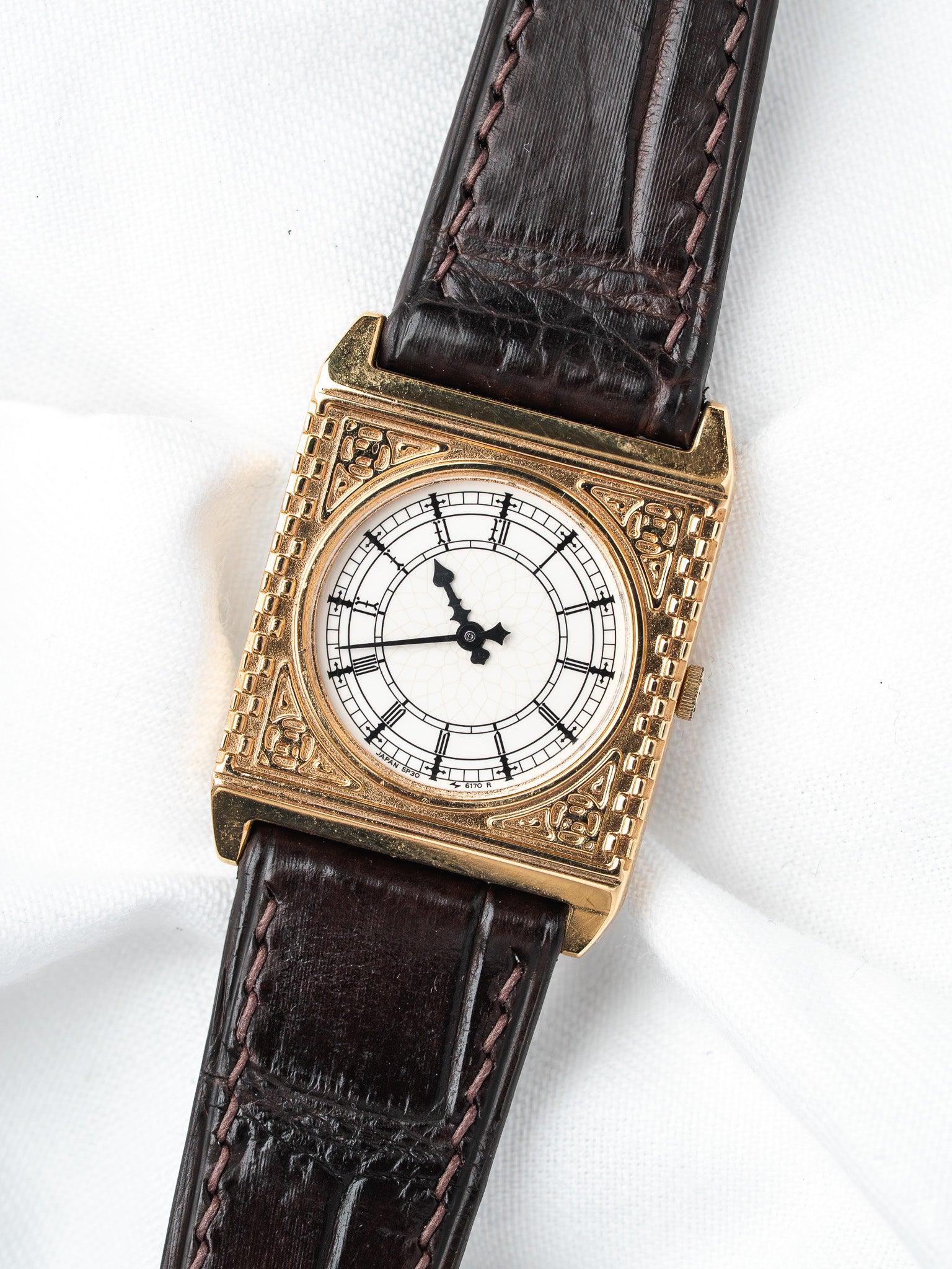 Vintage Seiko square watch with gold case, white dial, and brown leather strap
