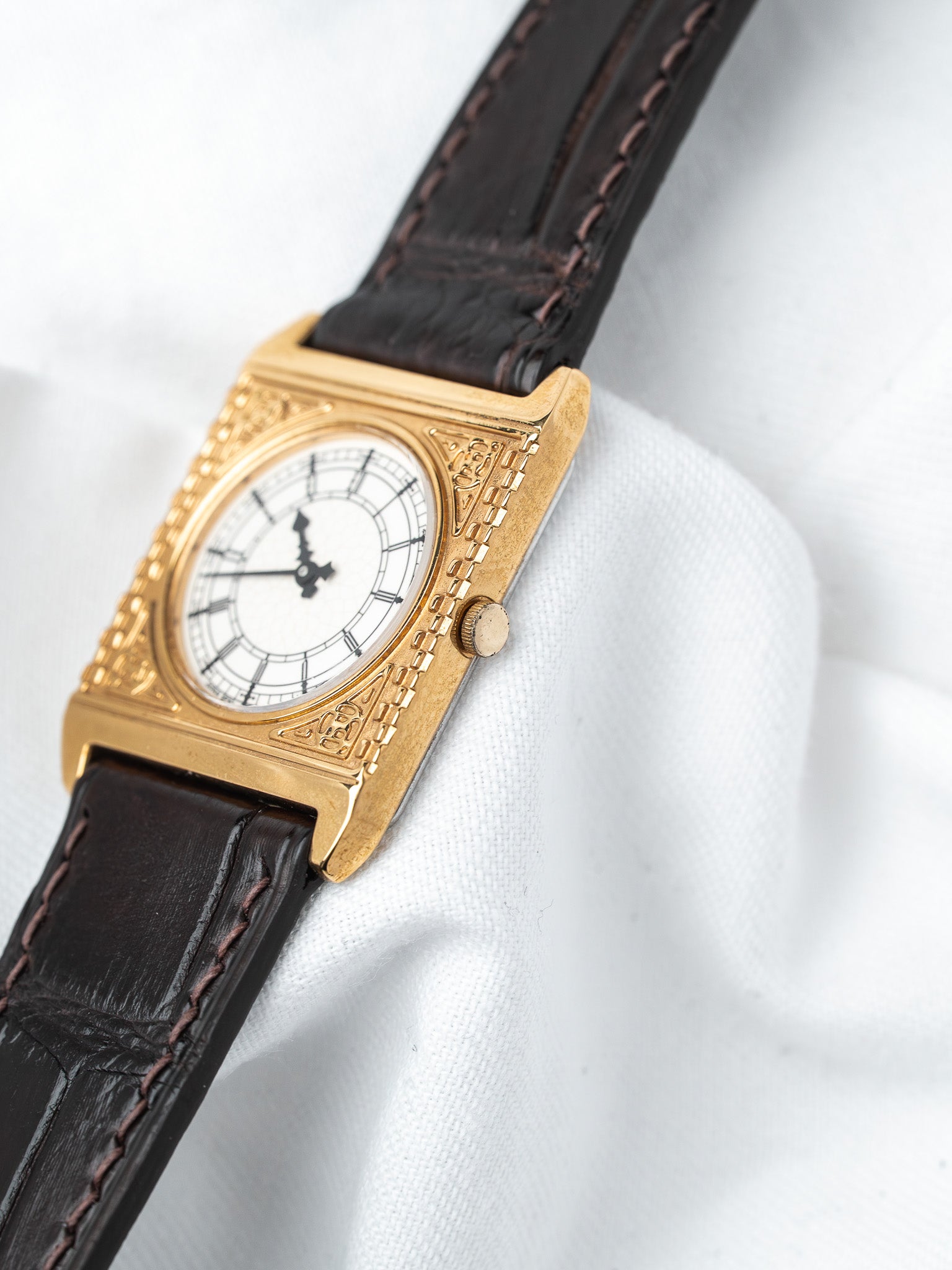 Cartier Tank vintage watch with gold case, white dial, Roman numerals, brown leather strap