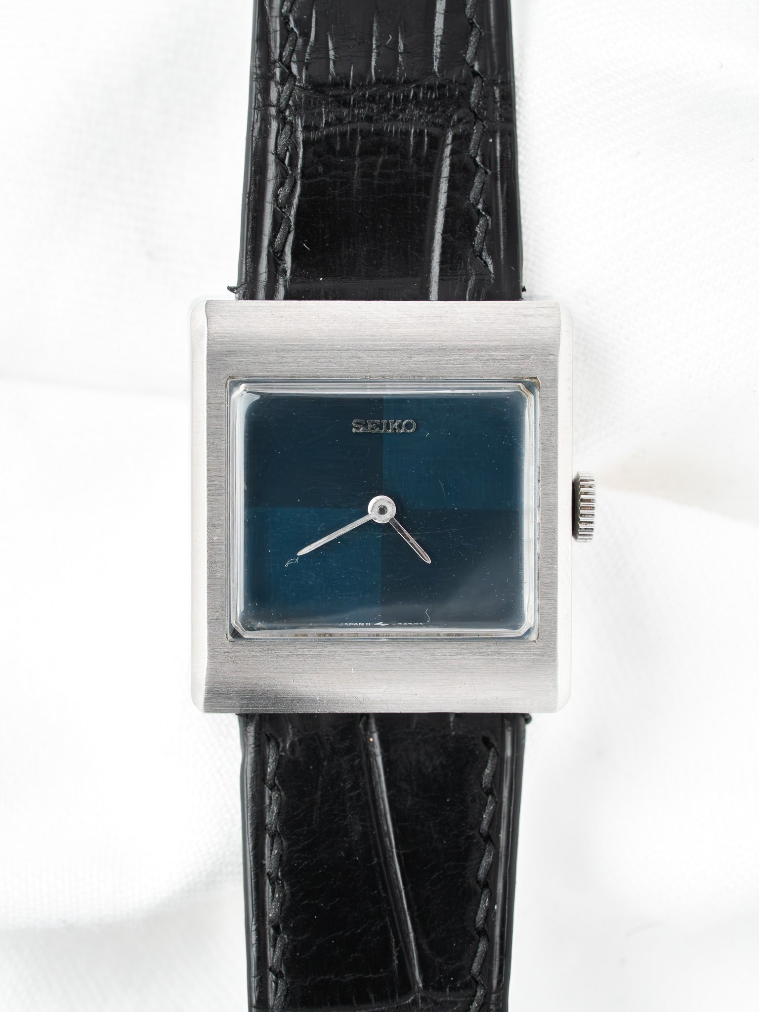 Seiko vintage watch with square silver case, blue dial, black leather strap