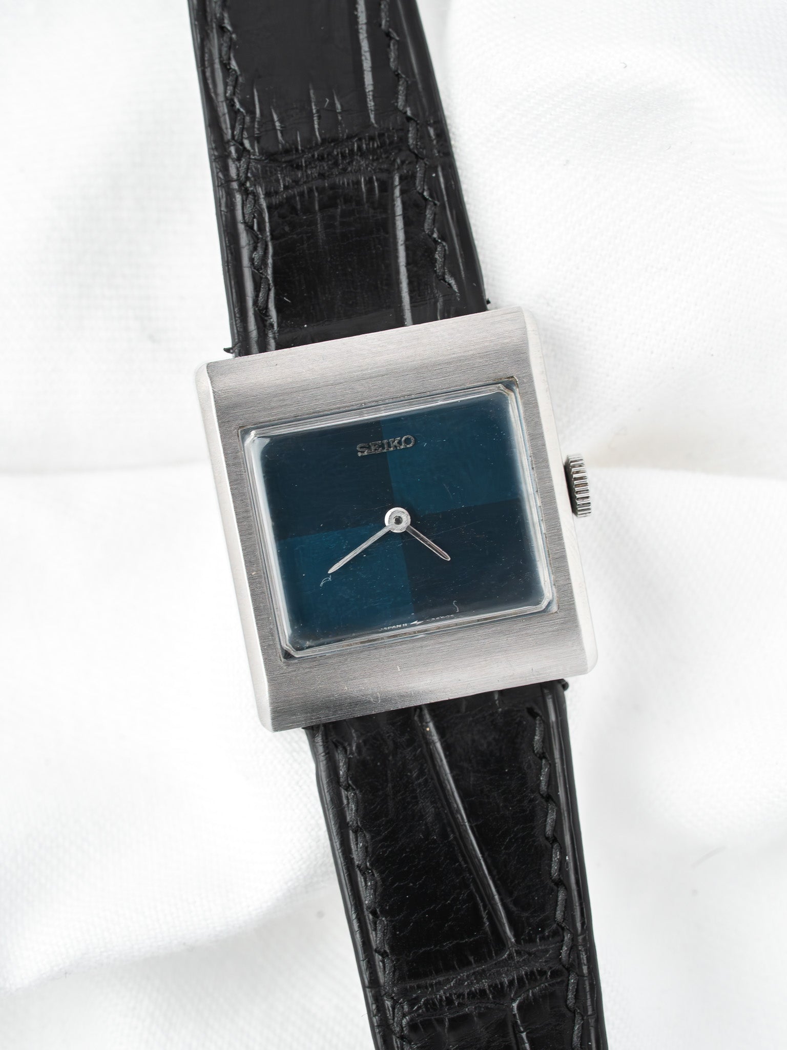 Seiko vintage watch with square silver case, blue dial, black leather strap