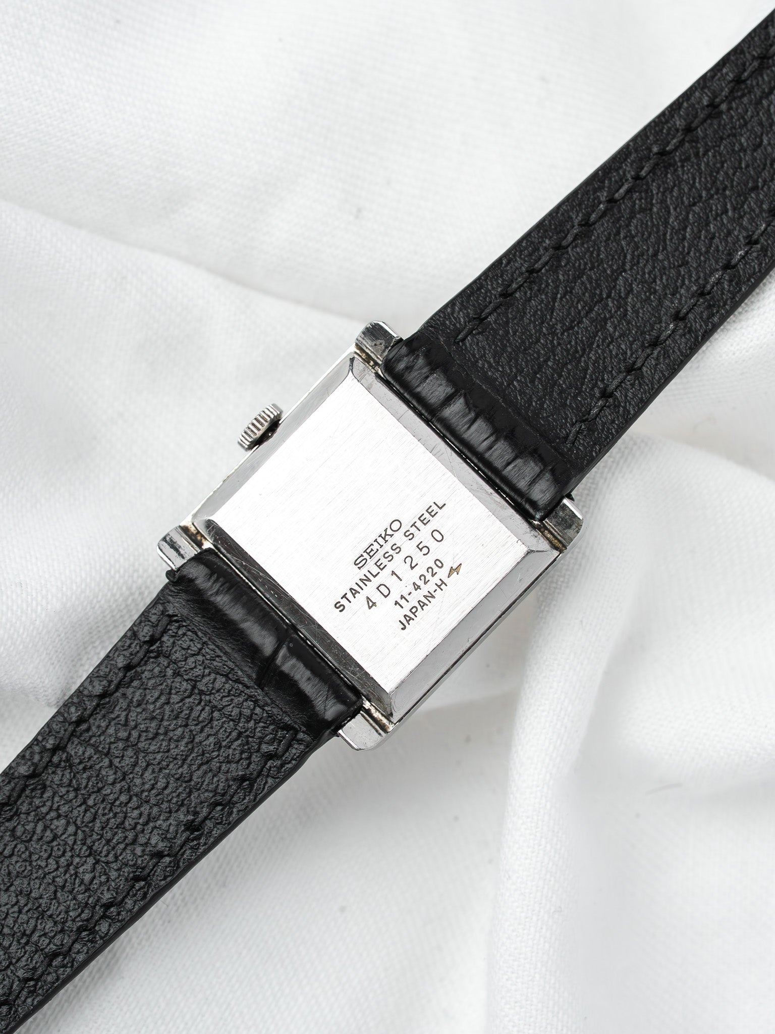 Seiko vintage watch with stainless steel case and black leather strap