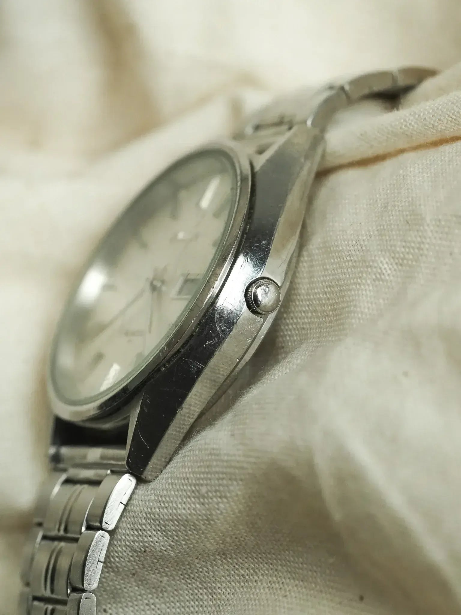 Vintage Seiko watch with silver dial and steel bracelet on fabric