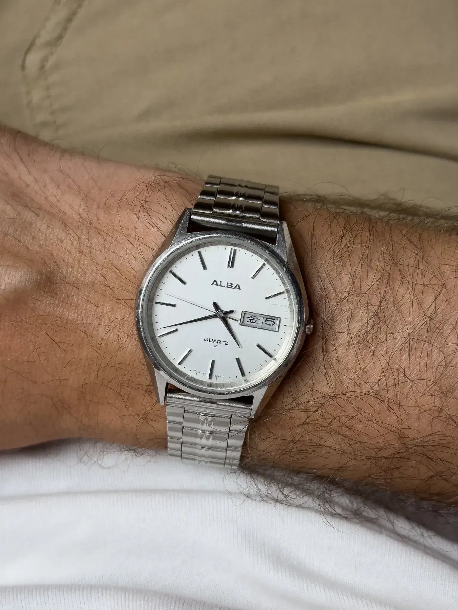 ALBA vintage quartz watch with white dial, day-date window, stainless steel bracelet on wrist