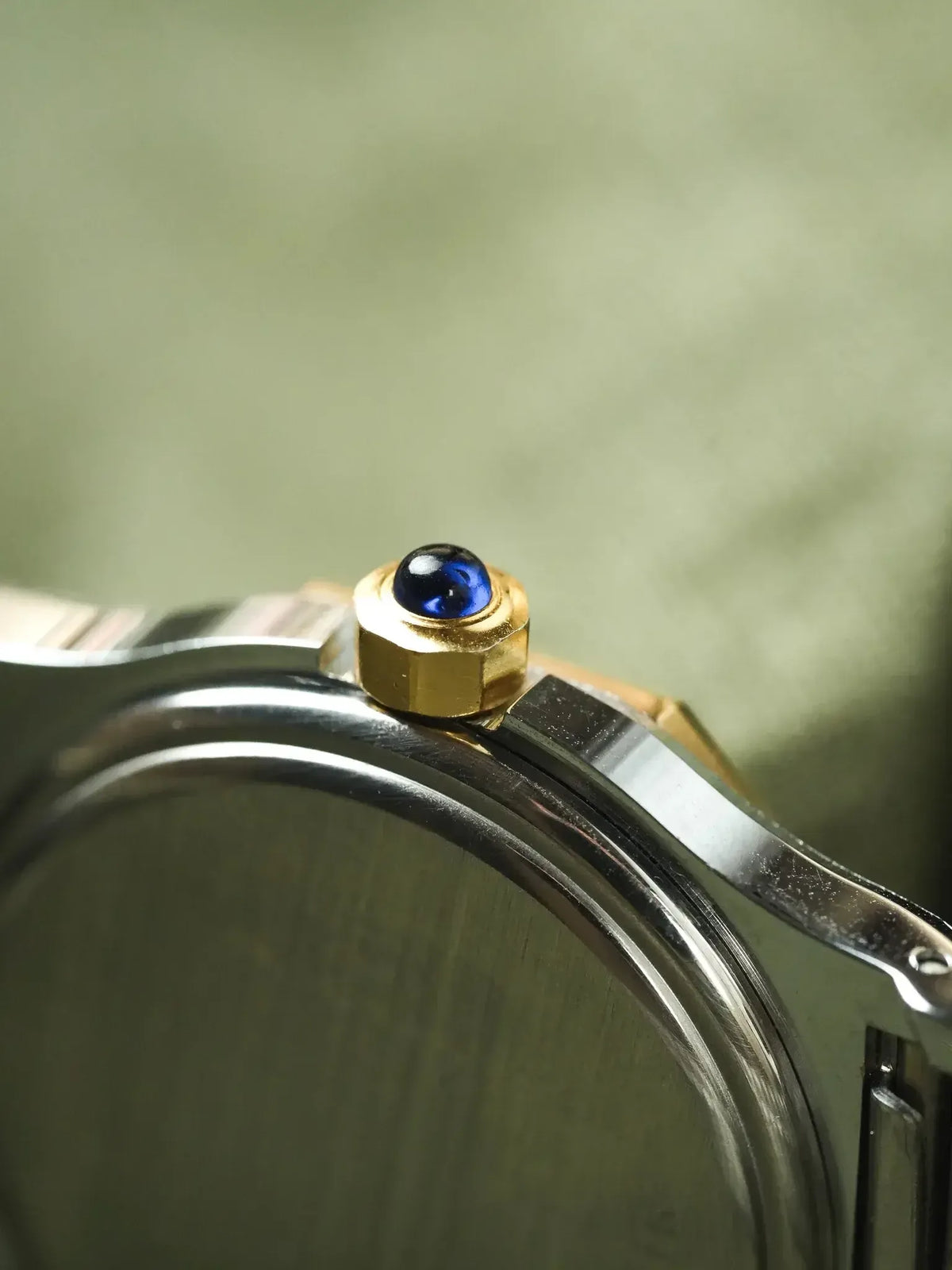 Cartier watch crown with blue cabochon, gold and steel case detail