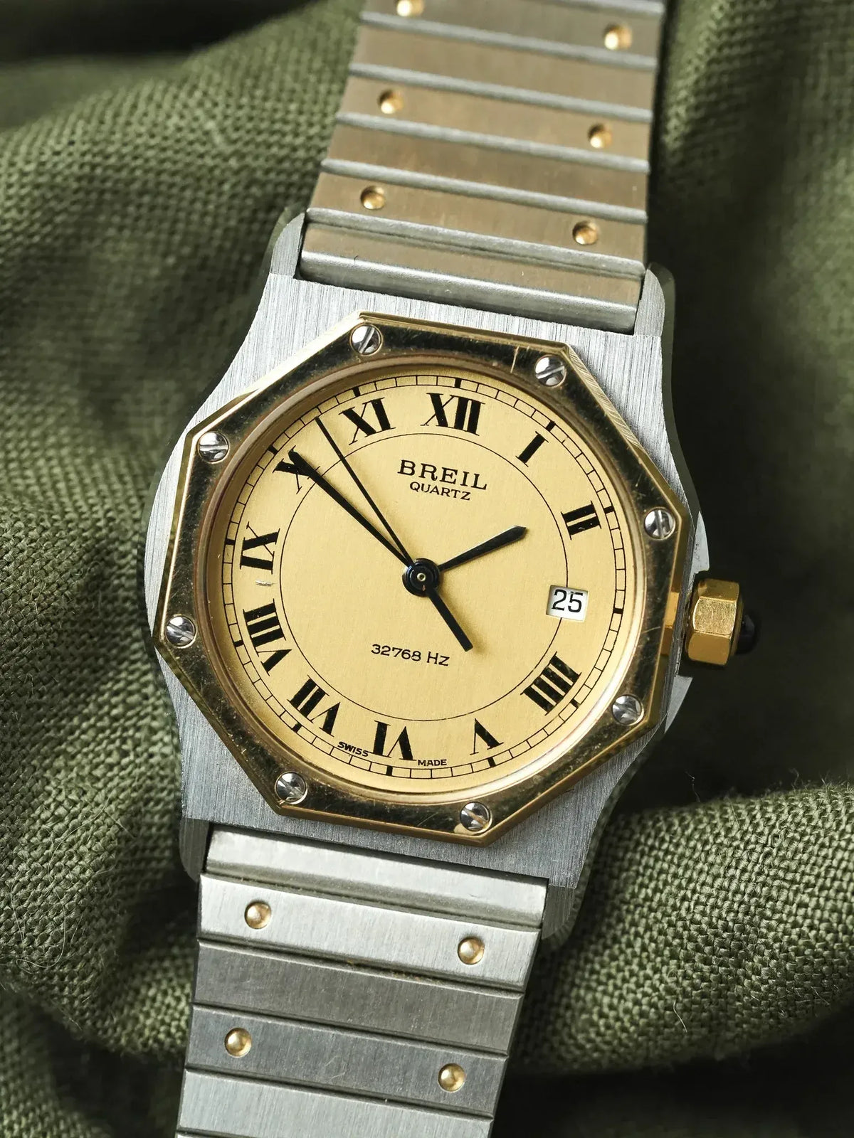 Breil quartz vintage watch with gold dial, Roman numerals, and two-tone steel bracelet