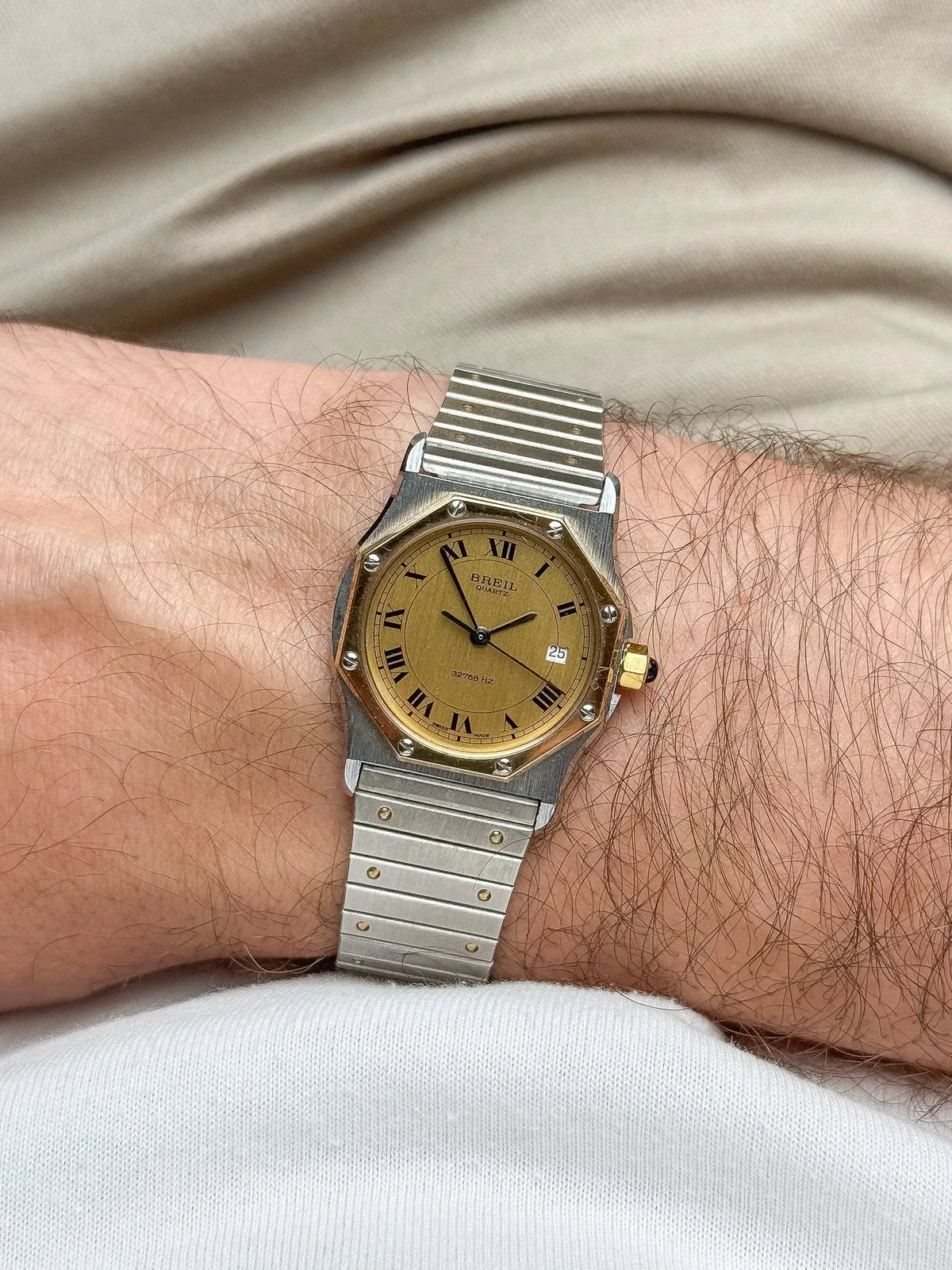 Breil quartz watch with gold dial, steel bracelet, worn on wrist