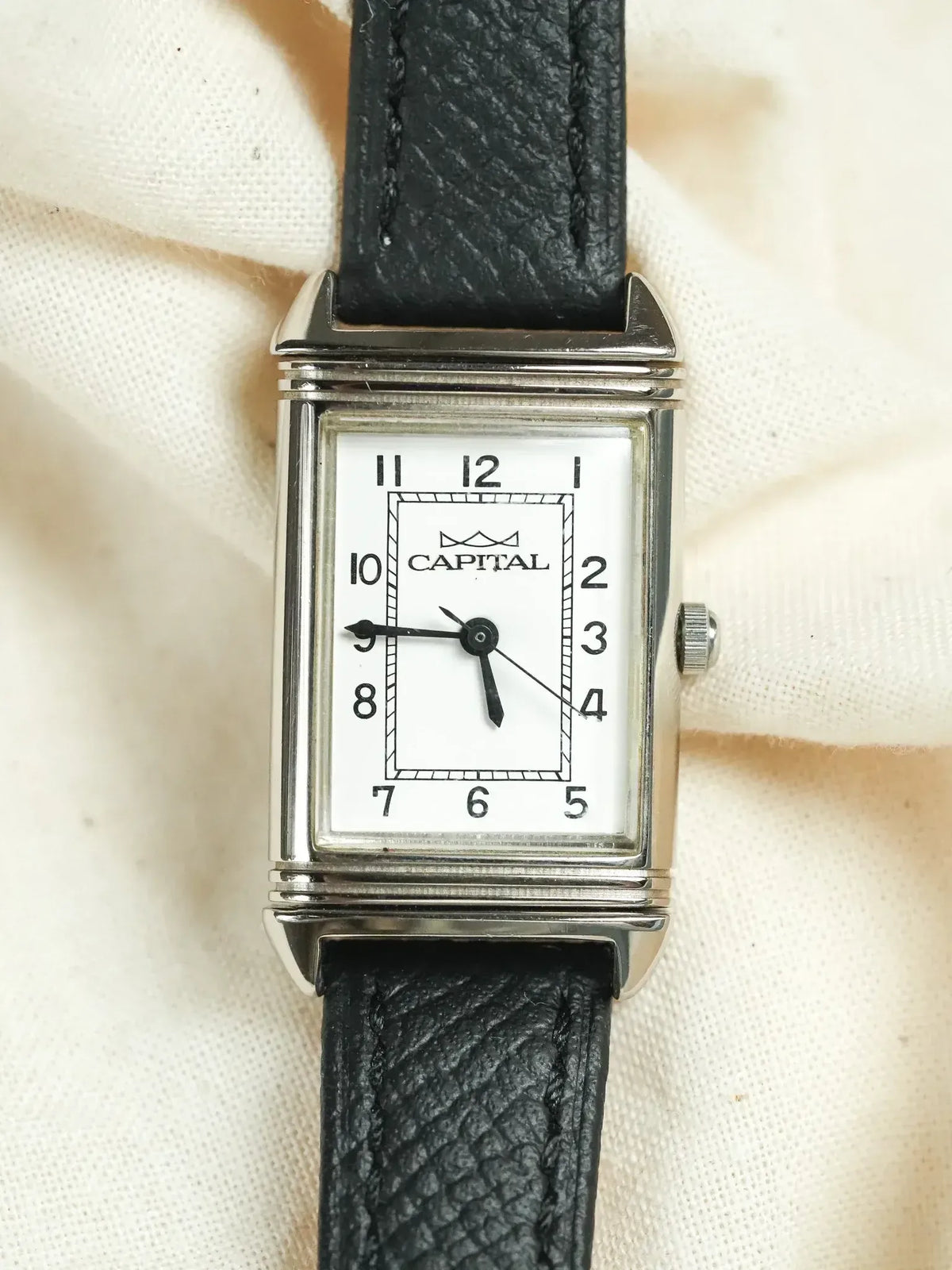 Capital vintage watch with rectangular silver case, white dial, black leather strap