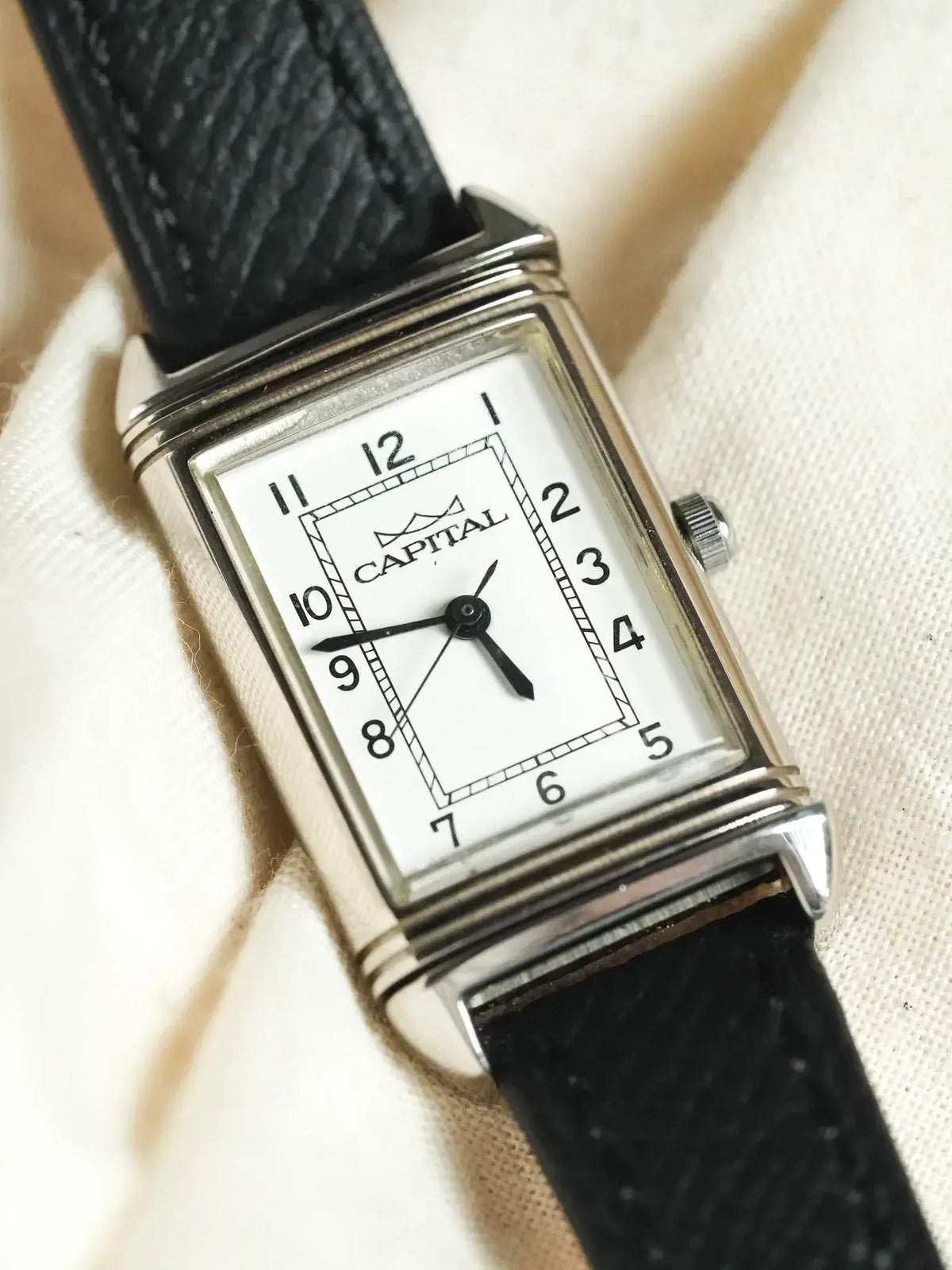 Capital vintage watch with rectangular silver case, white dial, black leather strap