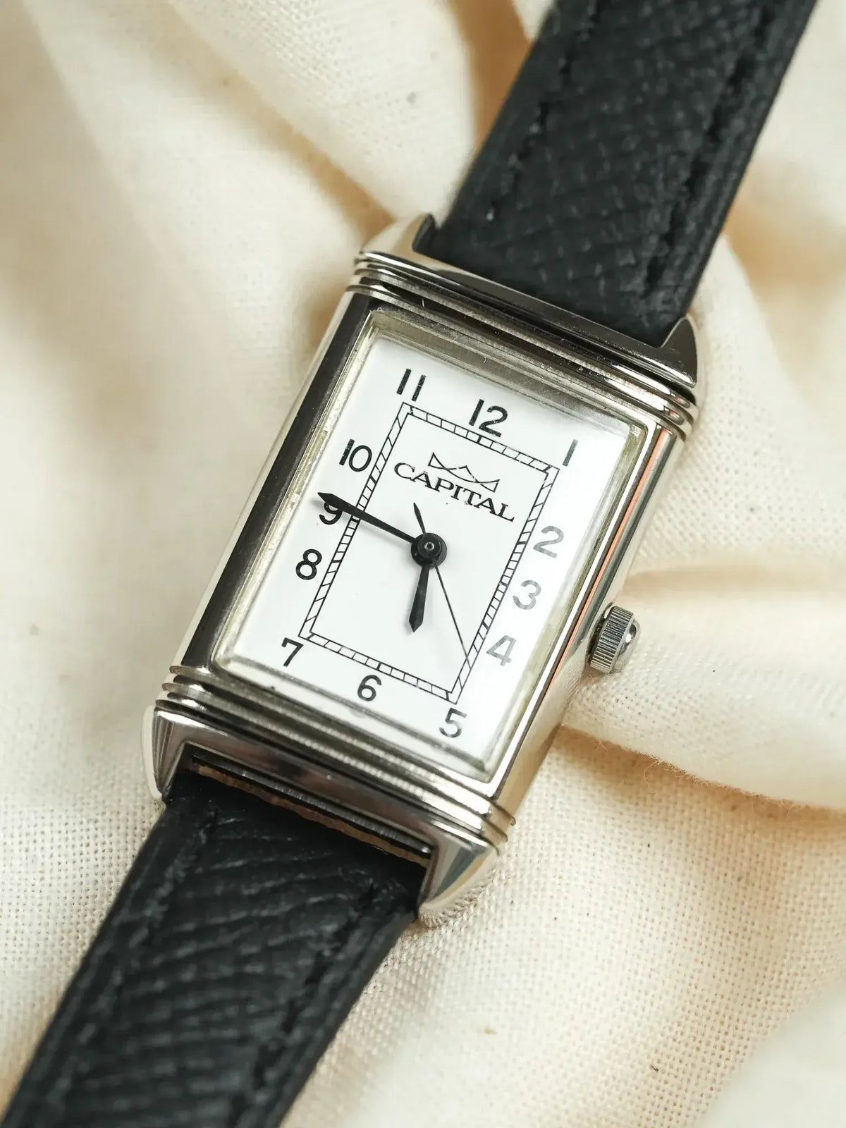 Capital vintage watch with rectangular silver case, white dial, black leather strap