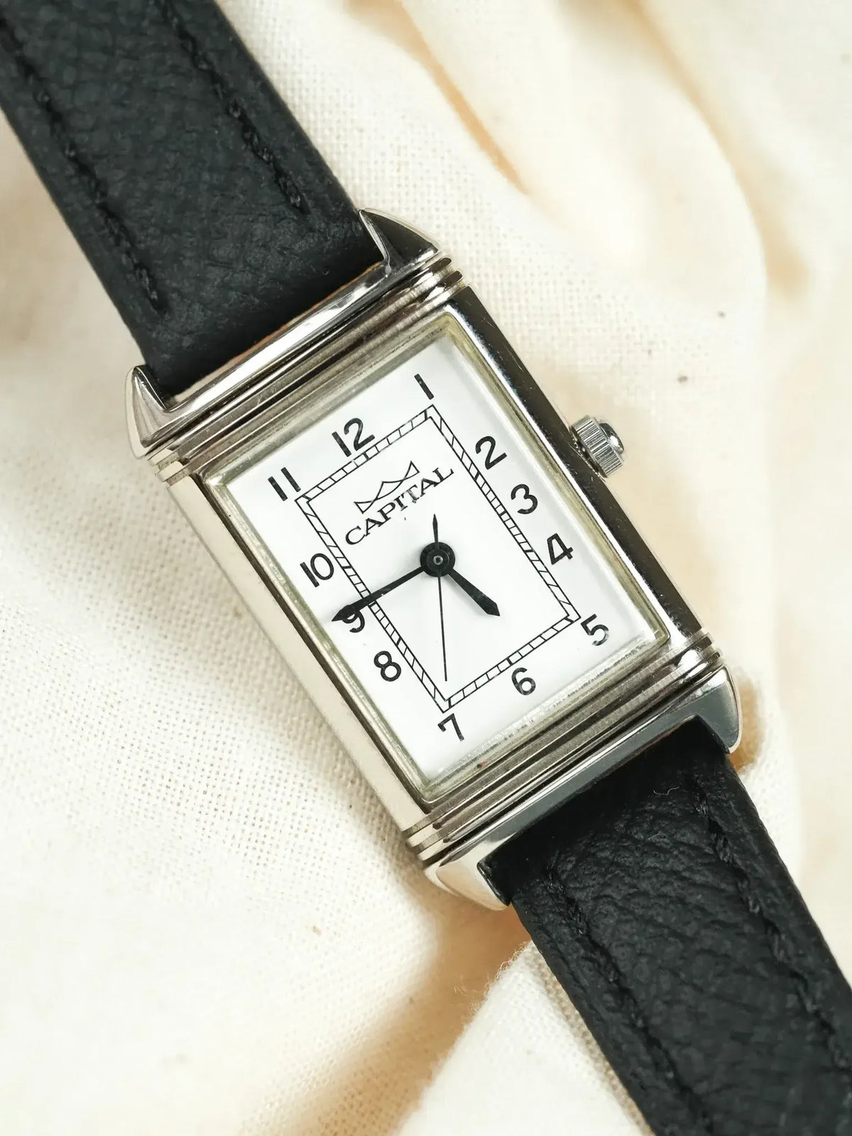 Vintage Capital watch with rectangular silver case, white dial, black leather strap