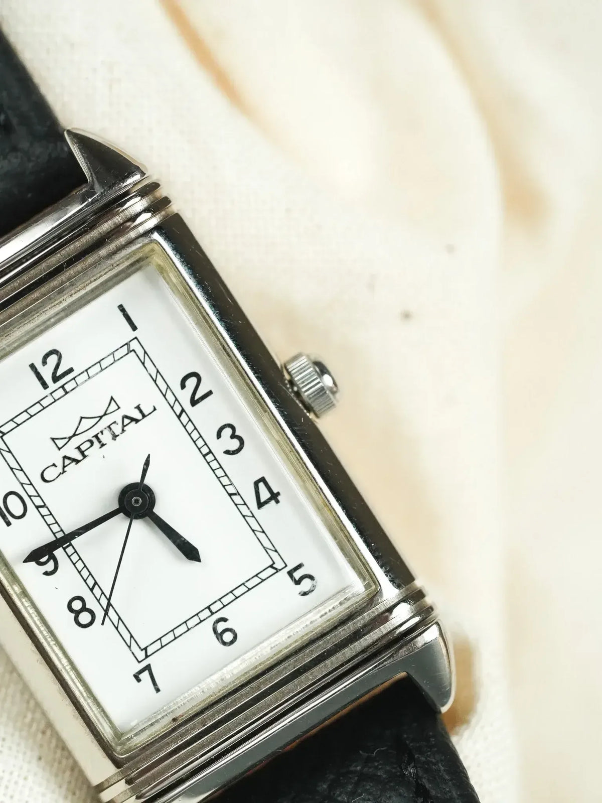 Capital vintage watch with rectangular silver case, white dial, black leather strap