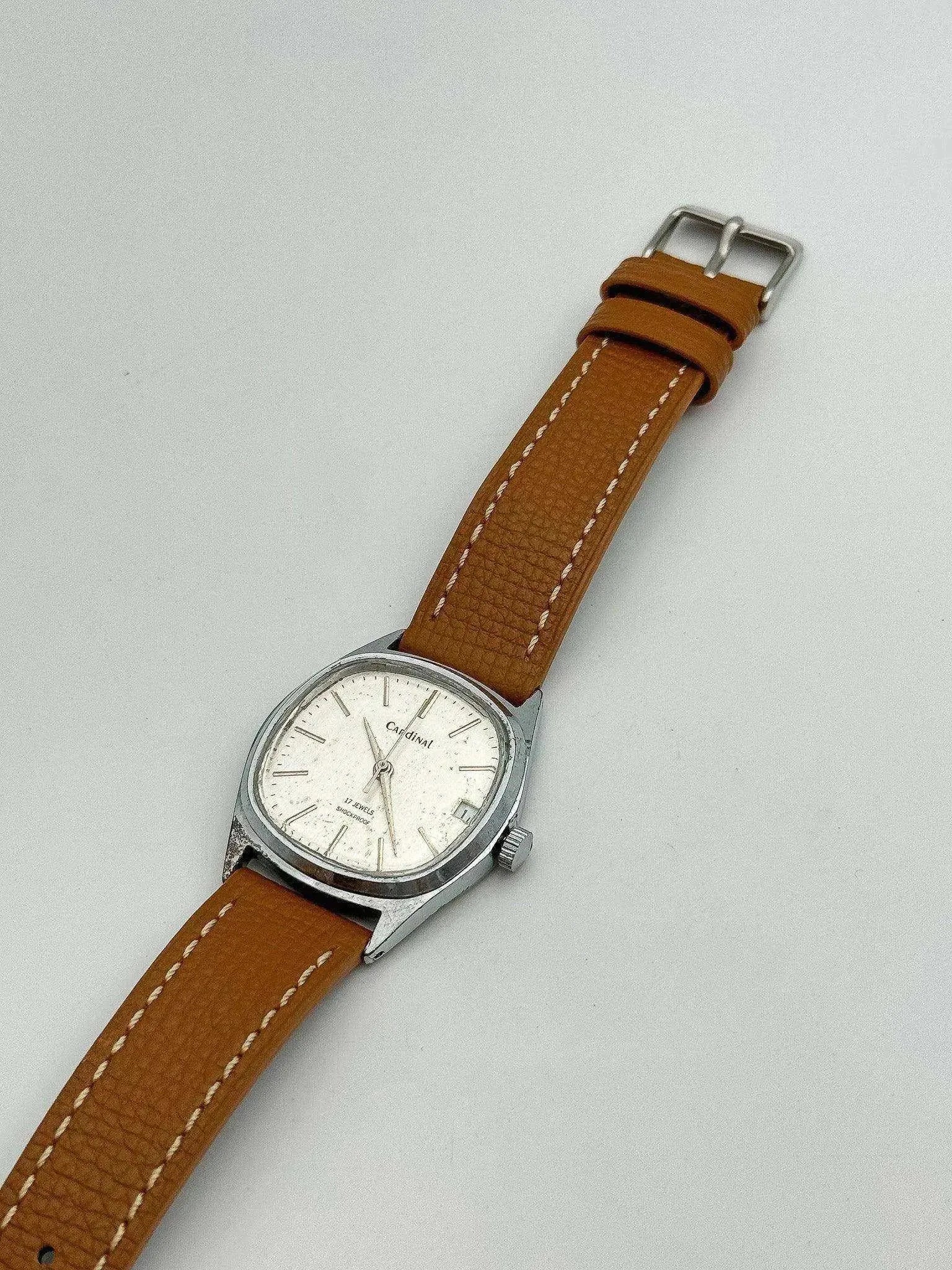 Cardinal vintage watch with silver case, white dial, and brown leather strap