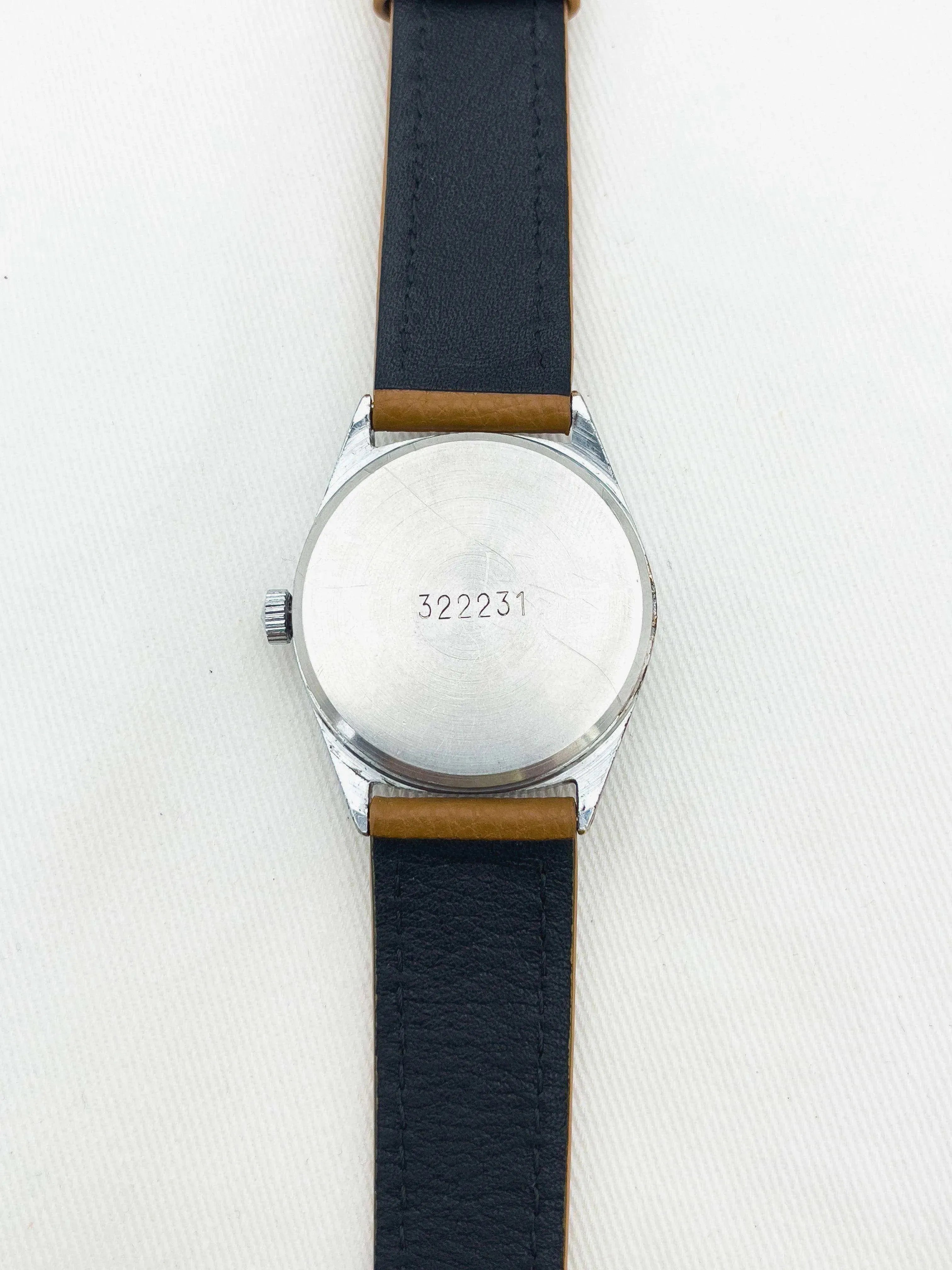 Vintage watch with stainless steel case, black leather strap, and engraved back number 322231