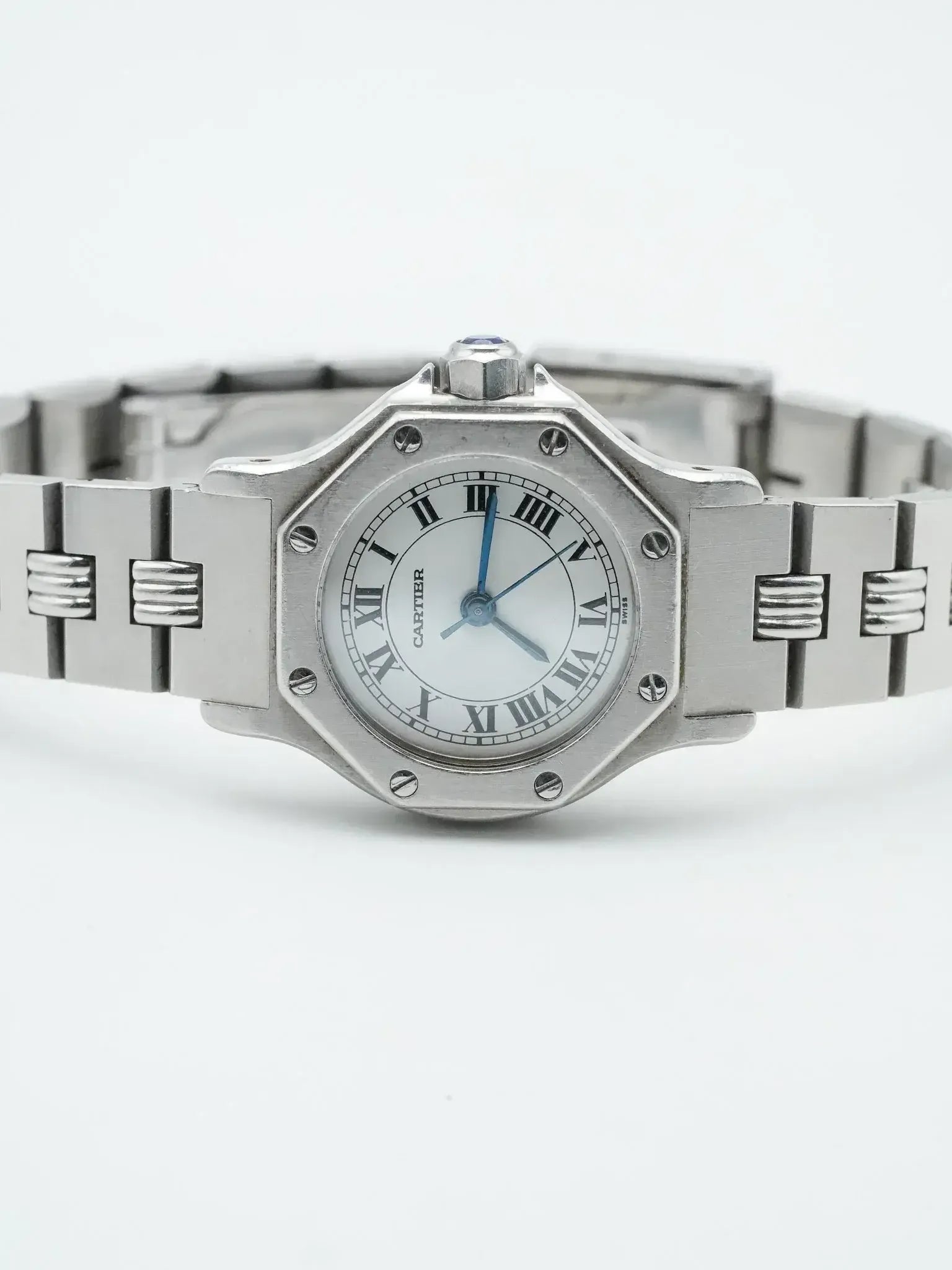 Cartier Santos watch with octagonal case, white dial, Roman numerals, and steel bracelet