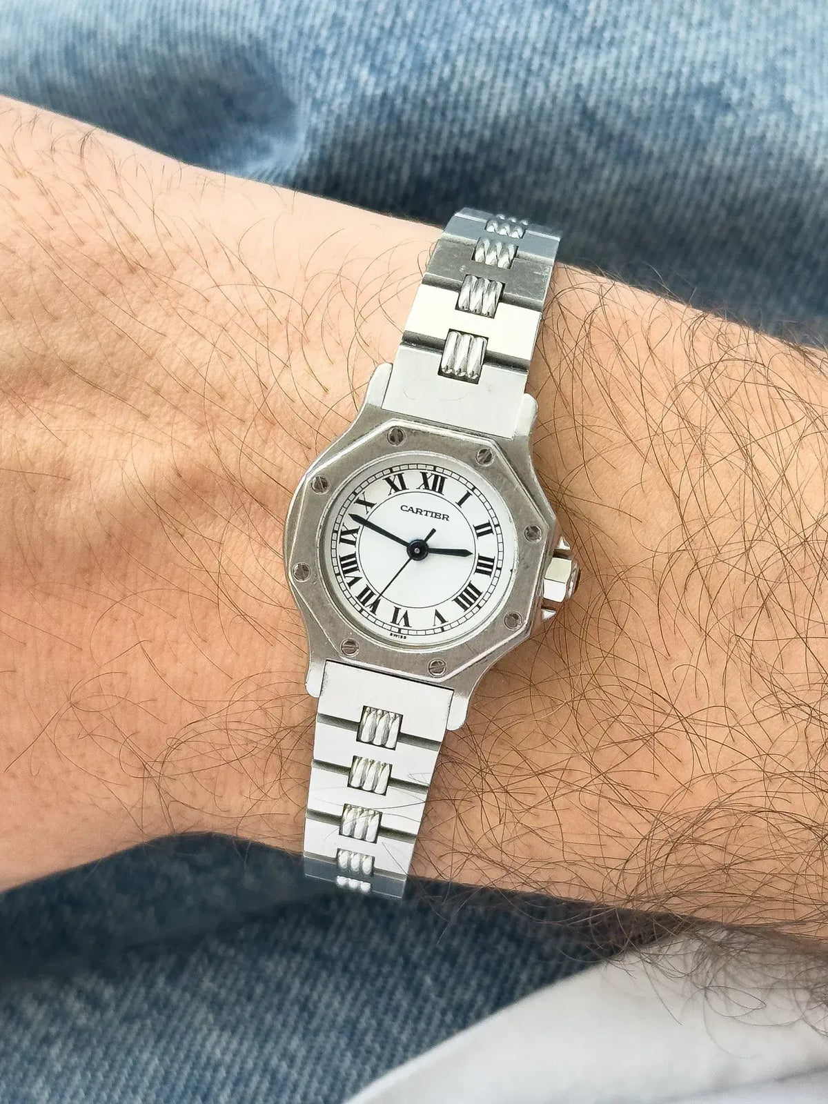 Cartier Santos watch with octagonal case, white dial, Roman numerals, worn on wrist