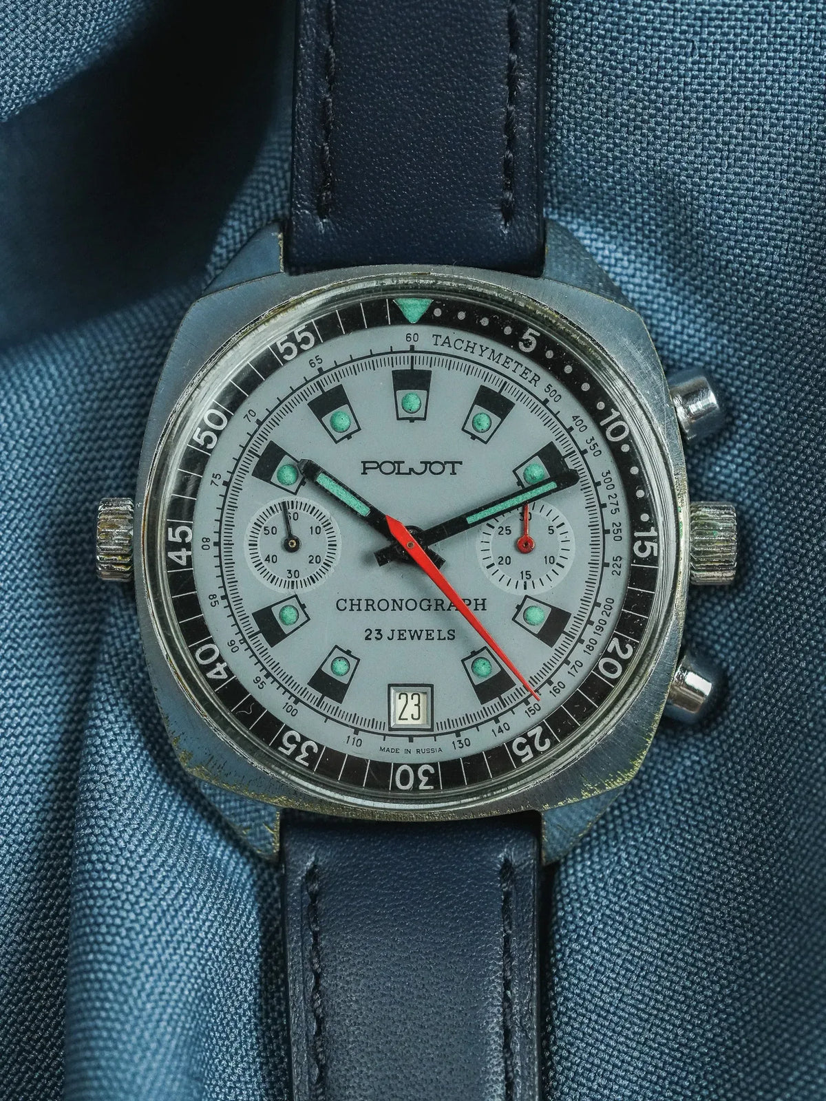 Vintage Poljot chronograph watch with grey dial, green markers, and blue leather strap