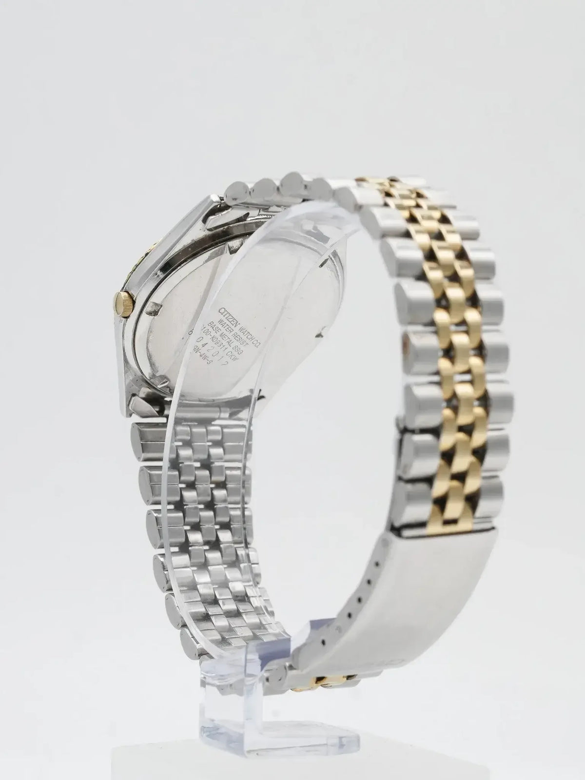 Citizen vintage watch with two-tone steel and gold bracelet, case back visible on stand