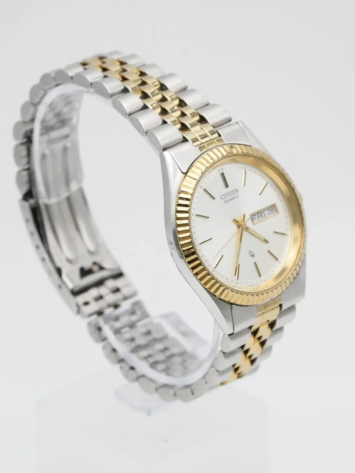 Citizen Quartz vintage watch with two-tone bracelet and white dial on display