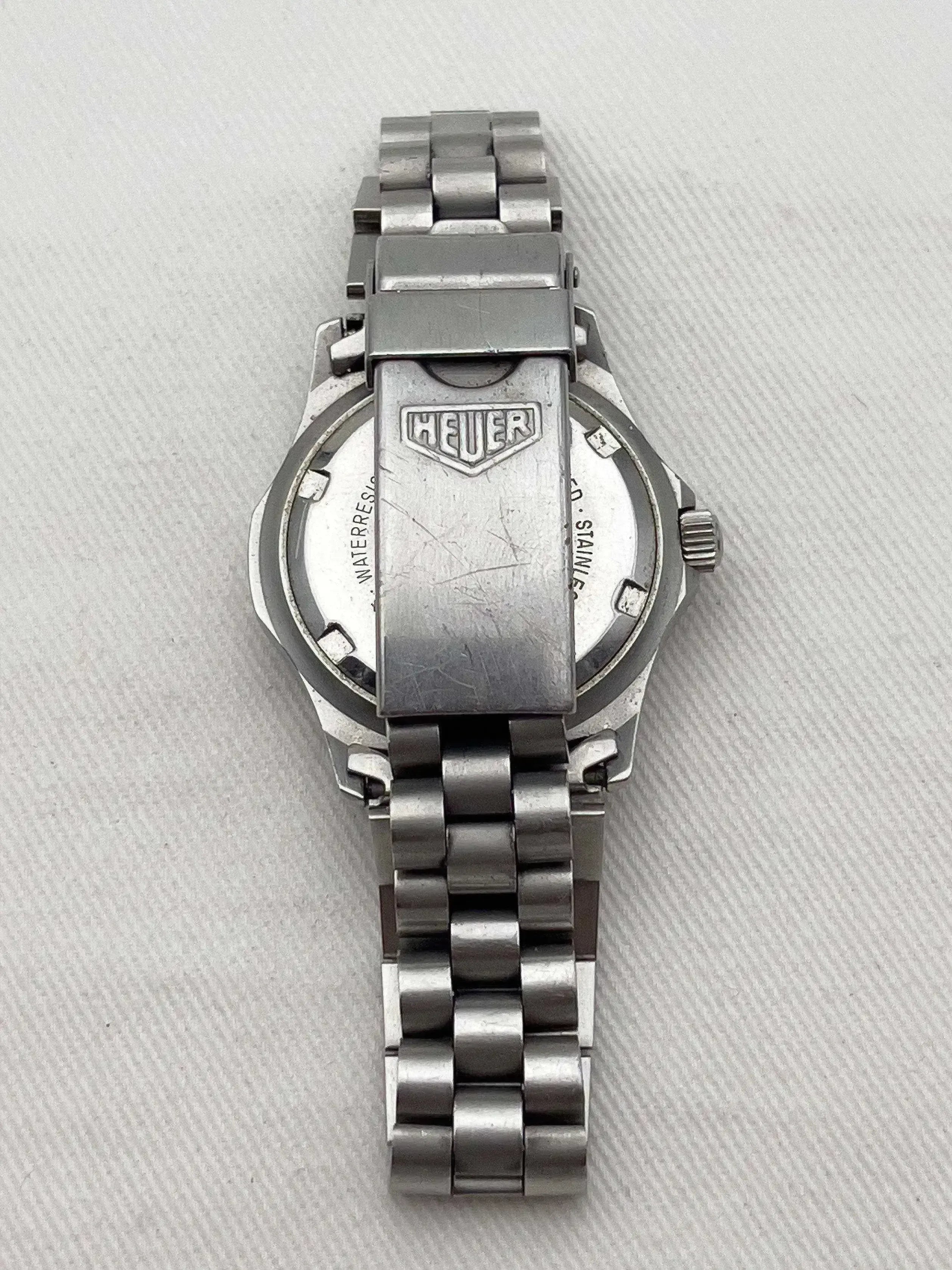 Heuer vintage watch back view, stainless steel case and bracelet, engraved logo