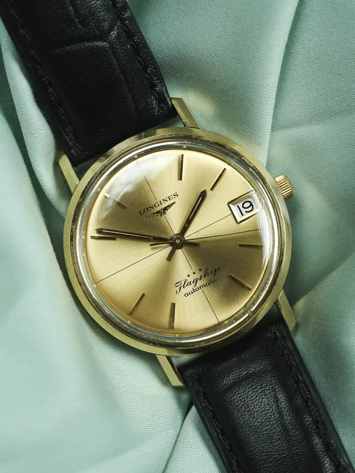 Longines Flagship vintage automatic watch, gold dial, black leather strap on mint fabric