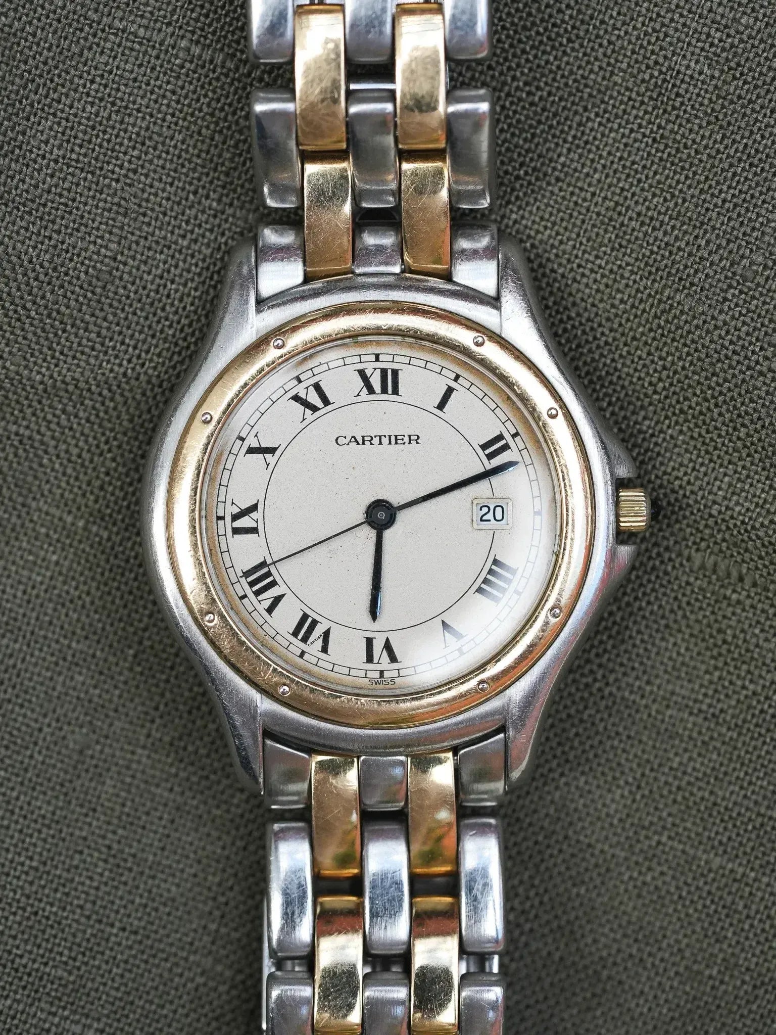 Cartier vintage watch with two-tone bracelet, white dial, Roman numerals, date window