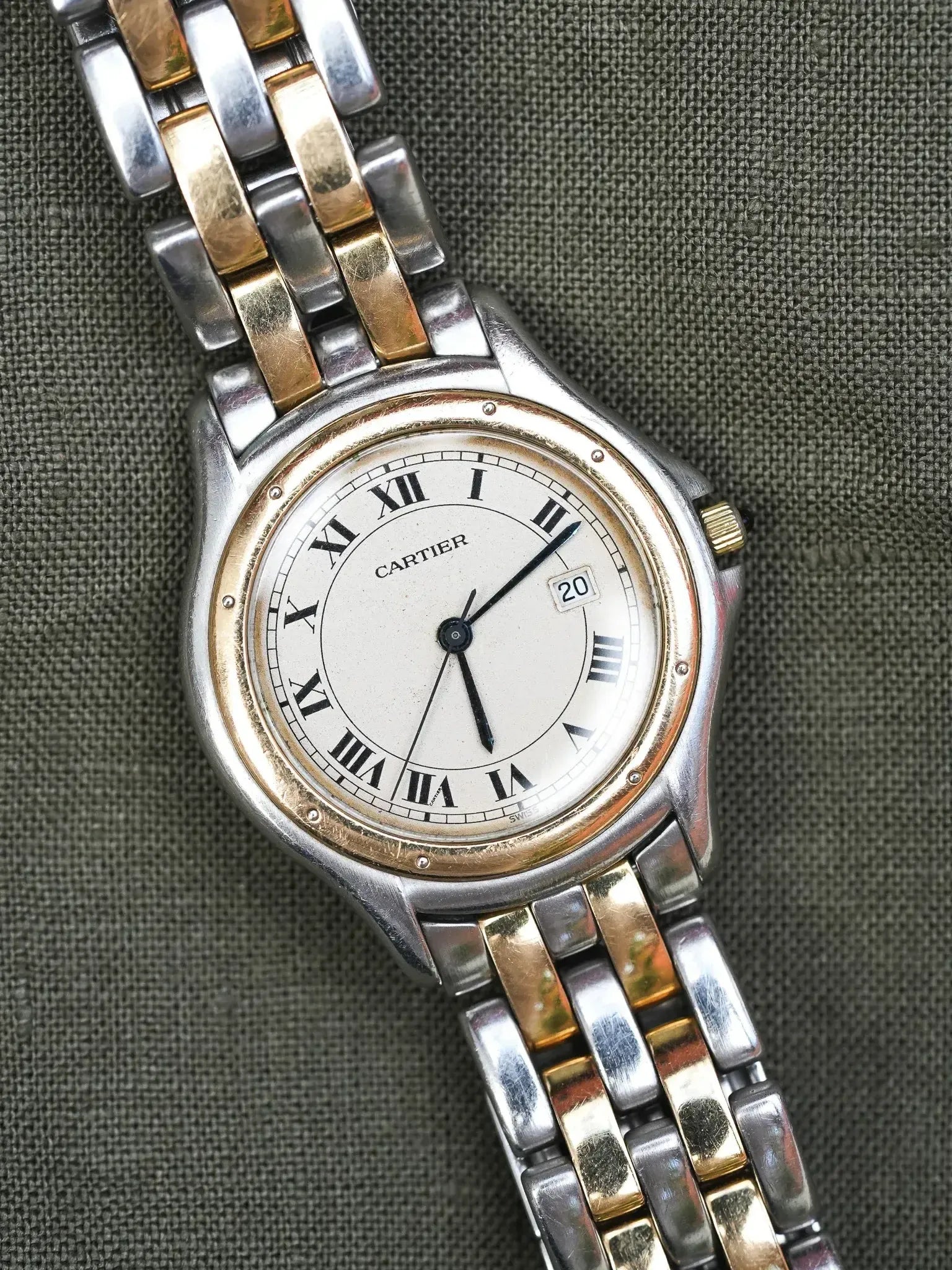 Cartier vintage watch with two-tone bracelet, white dial, Roman numerals, date window