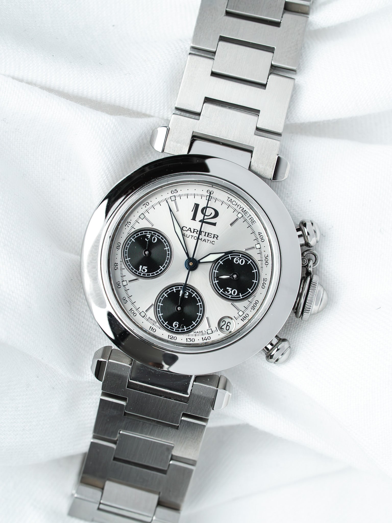 Cartier chronograph watch with silver dial, black subdials, and steel bracelet