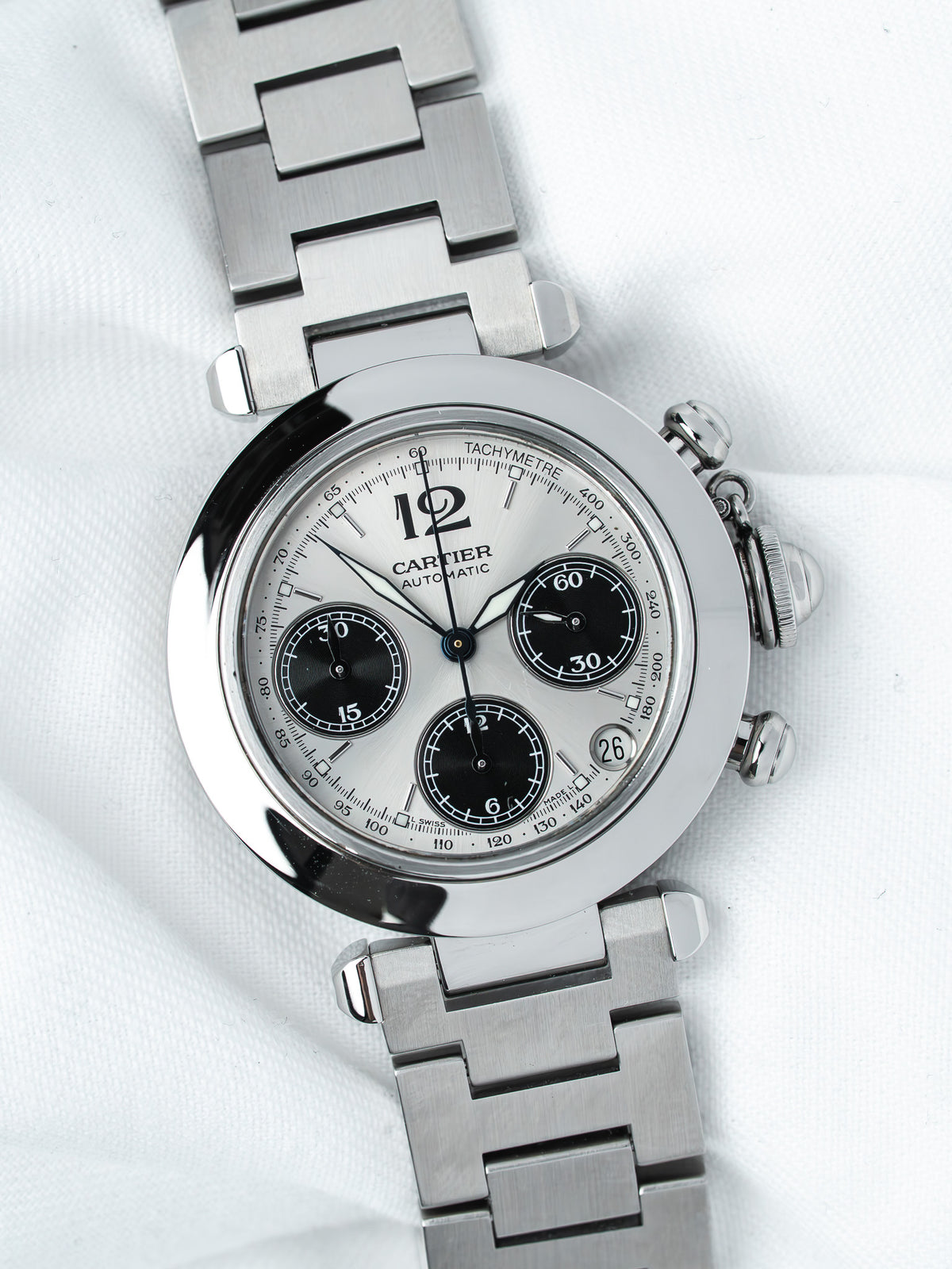 Cartier chronograph watch with silver dial, black subdials, and steel bracelet