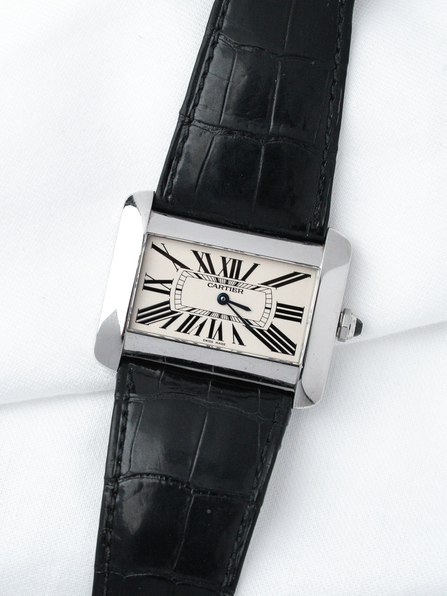 Cartier Tank vintage watch with white dial, black Roman numerals, and black alligator strap on white background