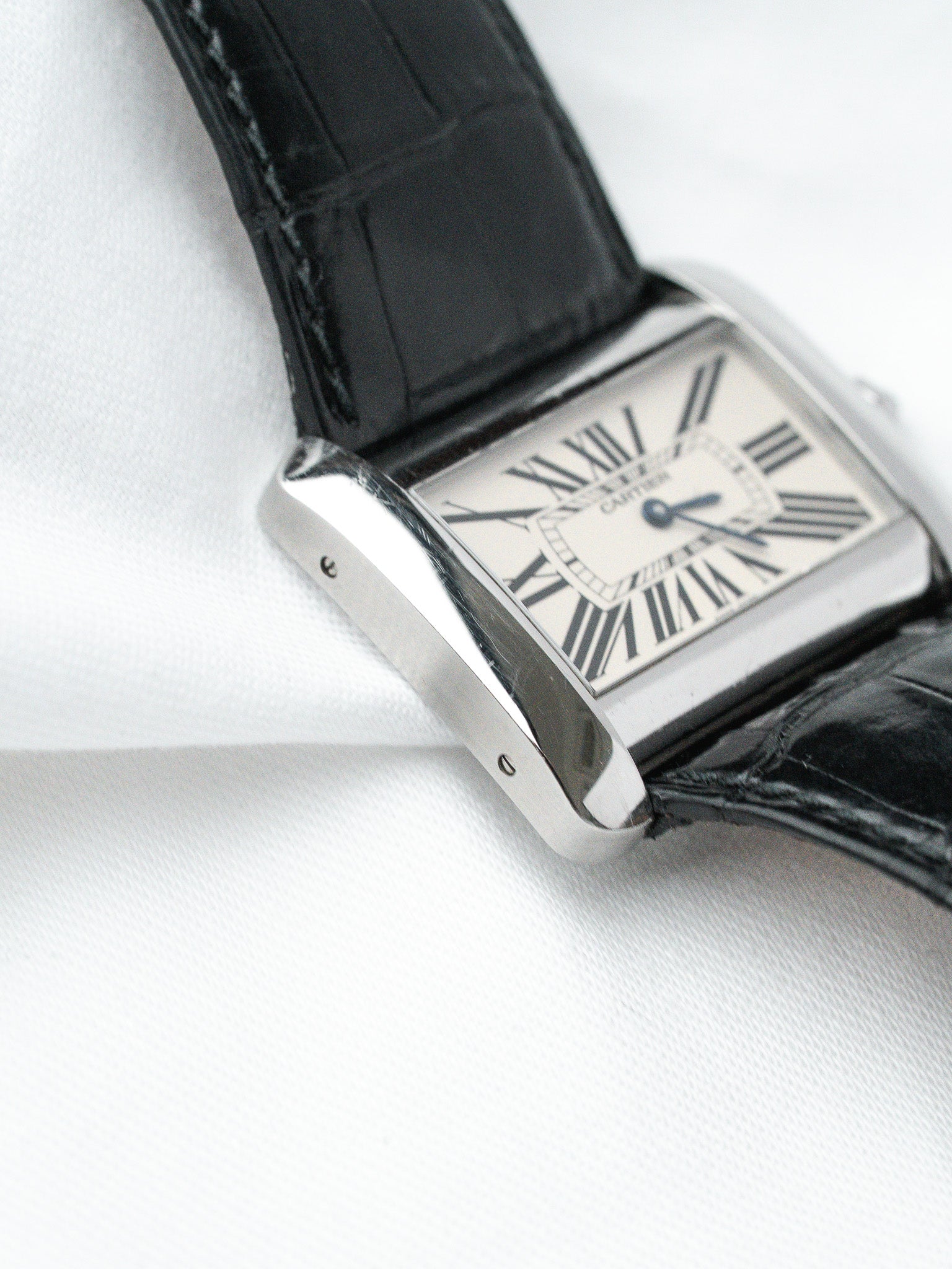 Cartier Tank watch with silver case, white dial, Roman numerals, black alligator strap