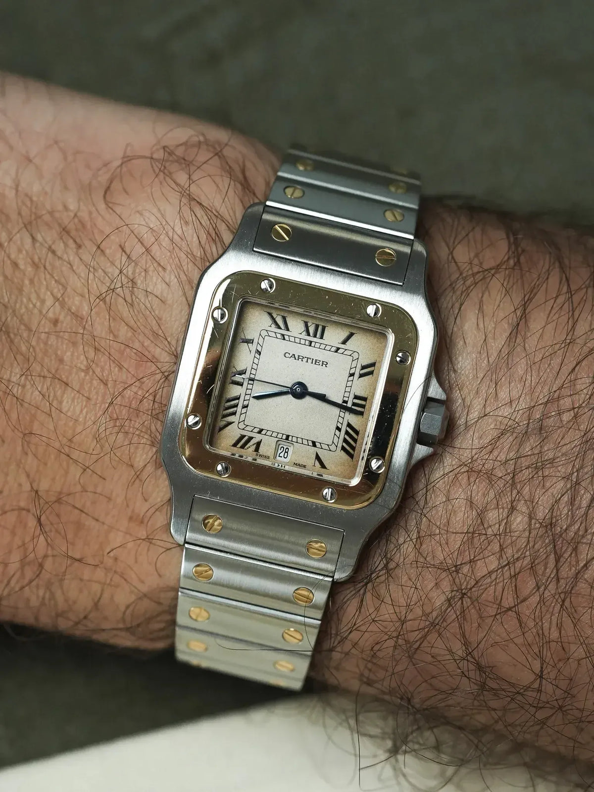 Cartier Santos vintage watch with two-tone steel and gold bracelet, cream dial, worn on wrist