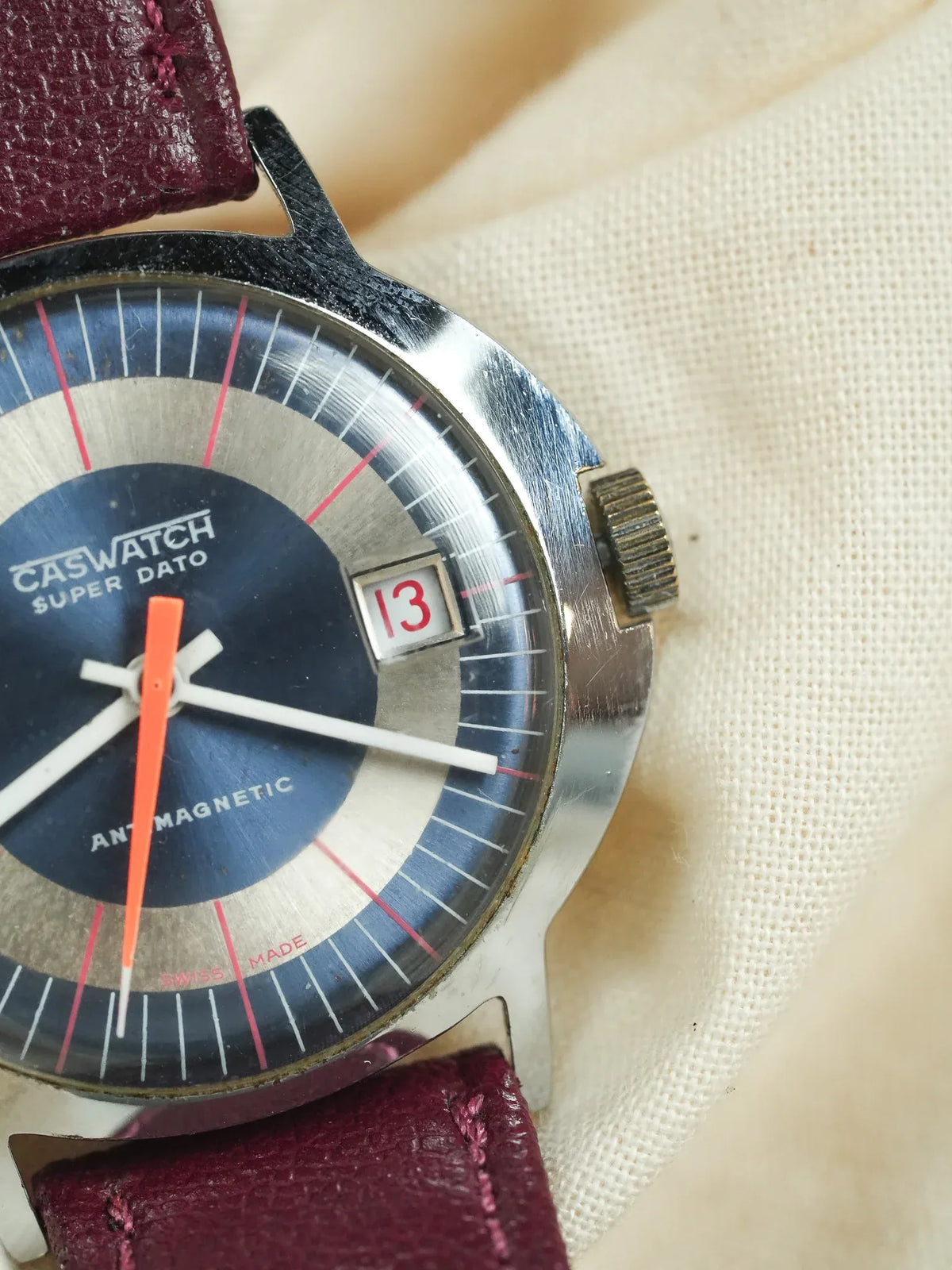 Caswatch Super Dato vintage watch with blue dial, orange seconds hand, burgundy leather strap