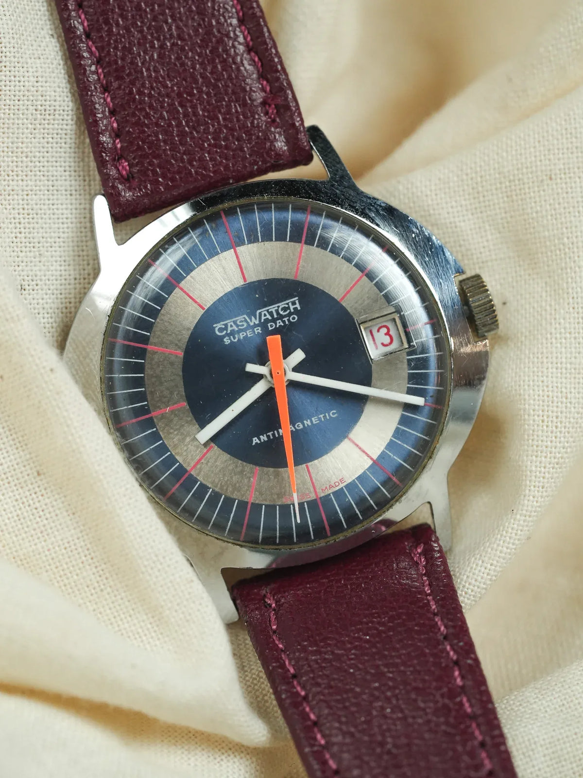 Caswatch Super Dato vintage watch with blue dial, red accents, burgundy leather strap