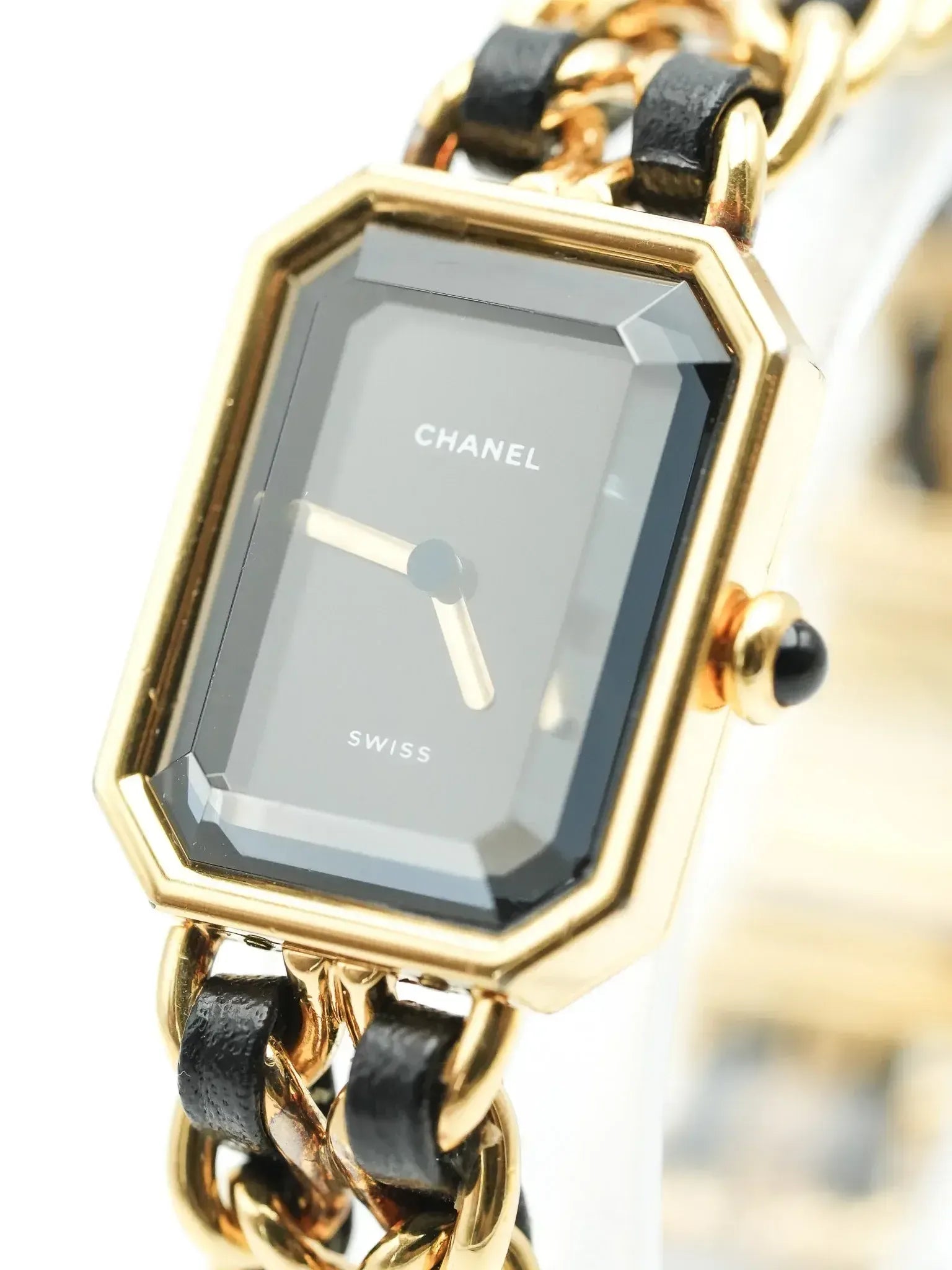 Chanel vintage watch with gold octagonal case, black dial, and chain-link bracelet