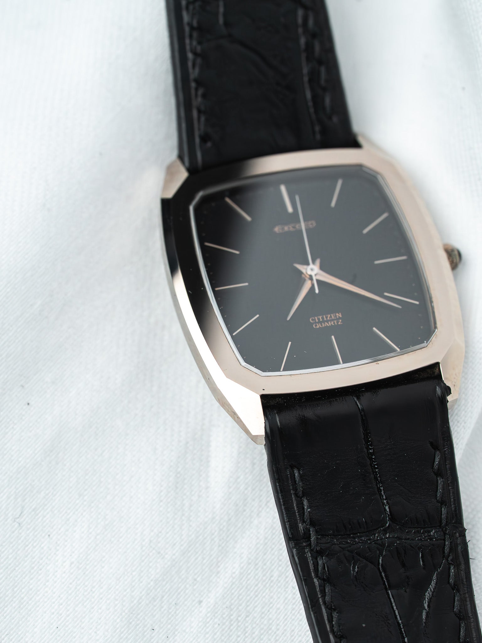 Citizen quartz watch with black dial, rose gold case, and black leather strap