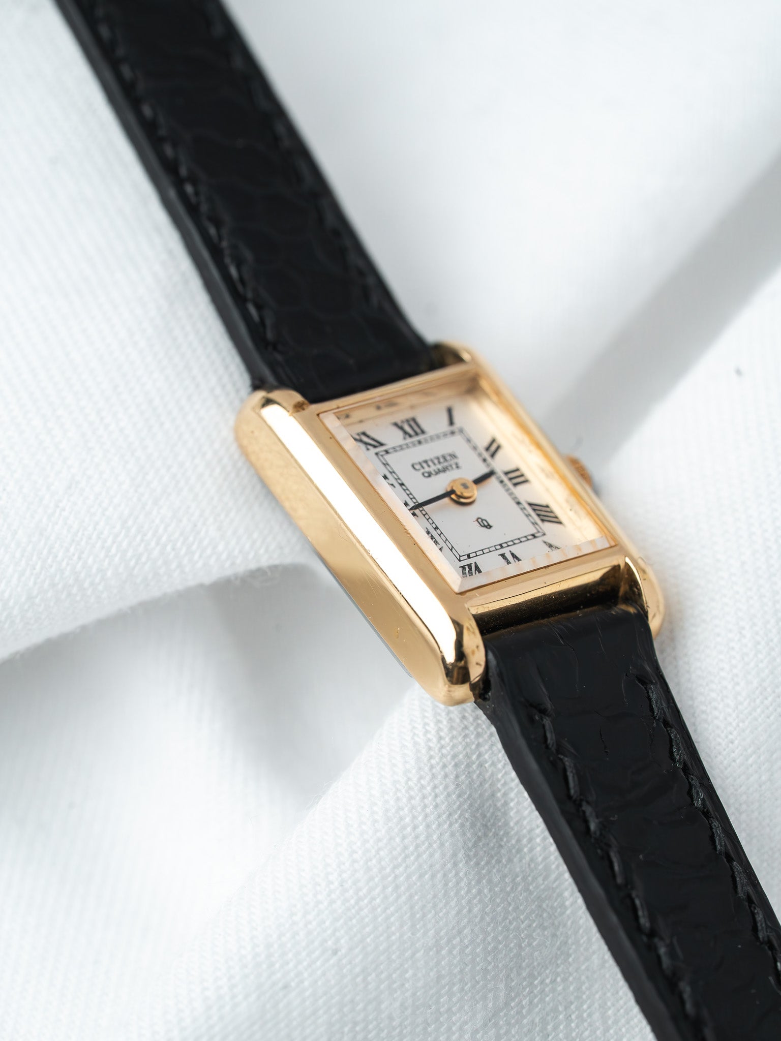 Citizen Quartz vintage watch with gold case, white dial, Roman numerals, black leather strap