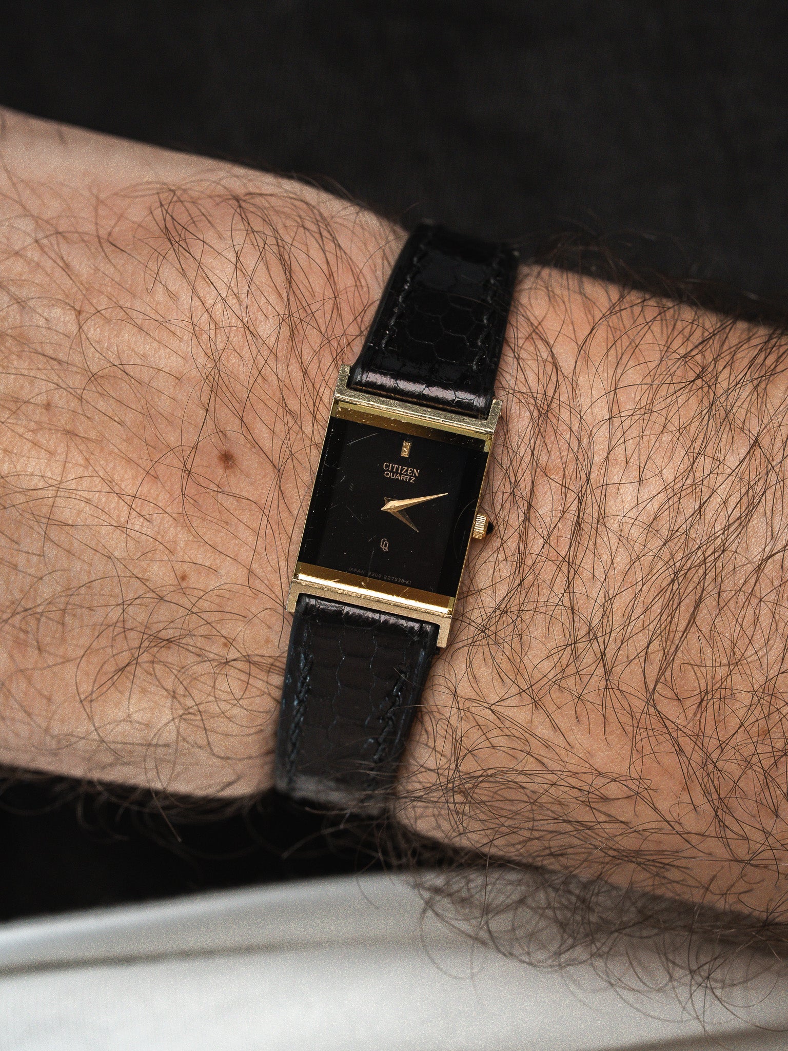Citizen Quartz vintage watch with gold case, black dial, and textured leather strap on wrist