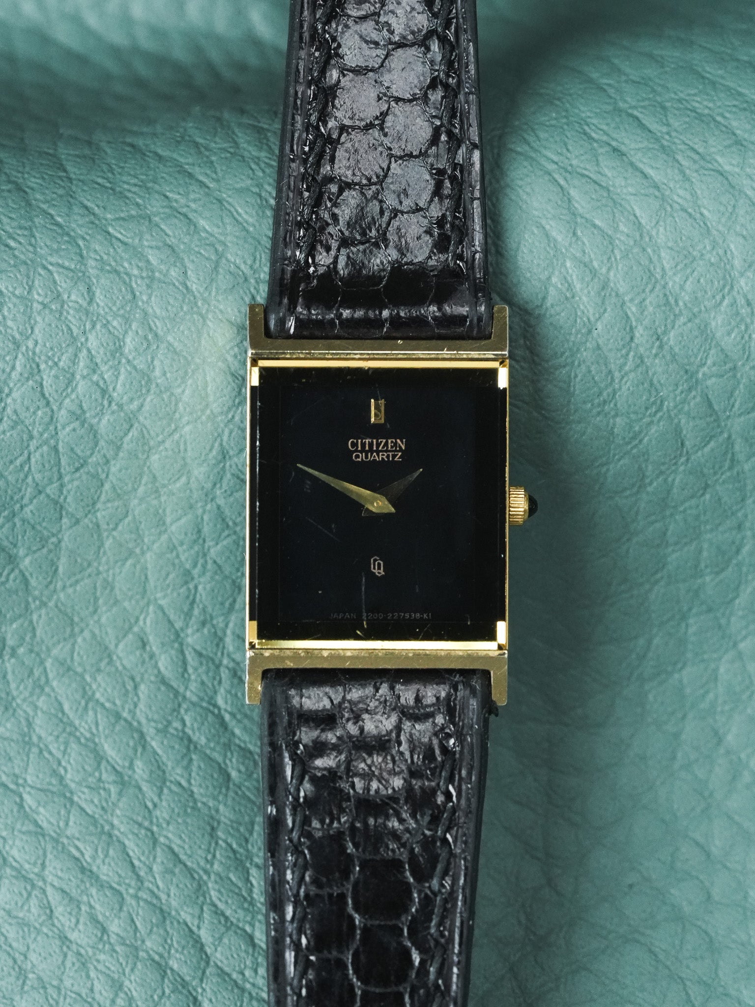 Citizen Quartz vintage watch with gold case, black dial, and textured black strap