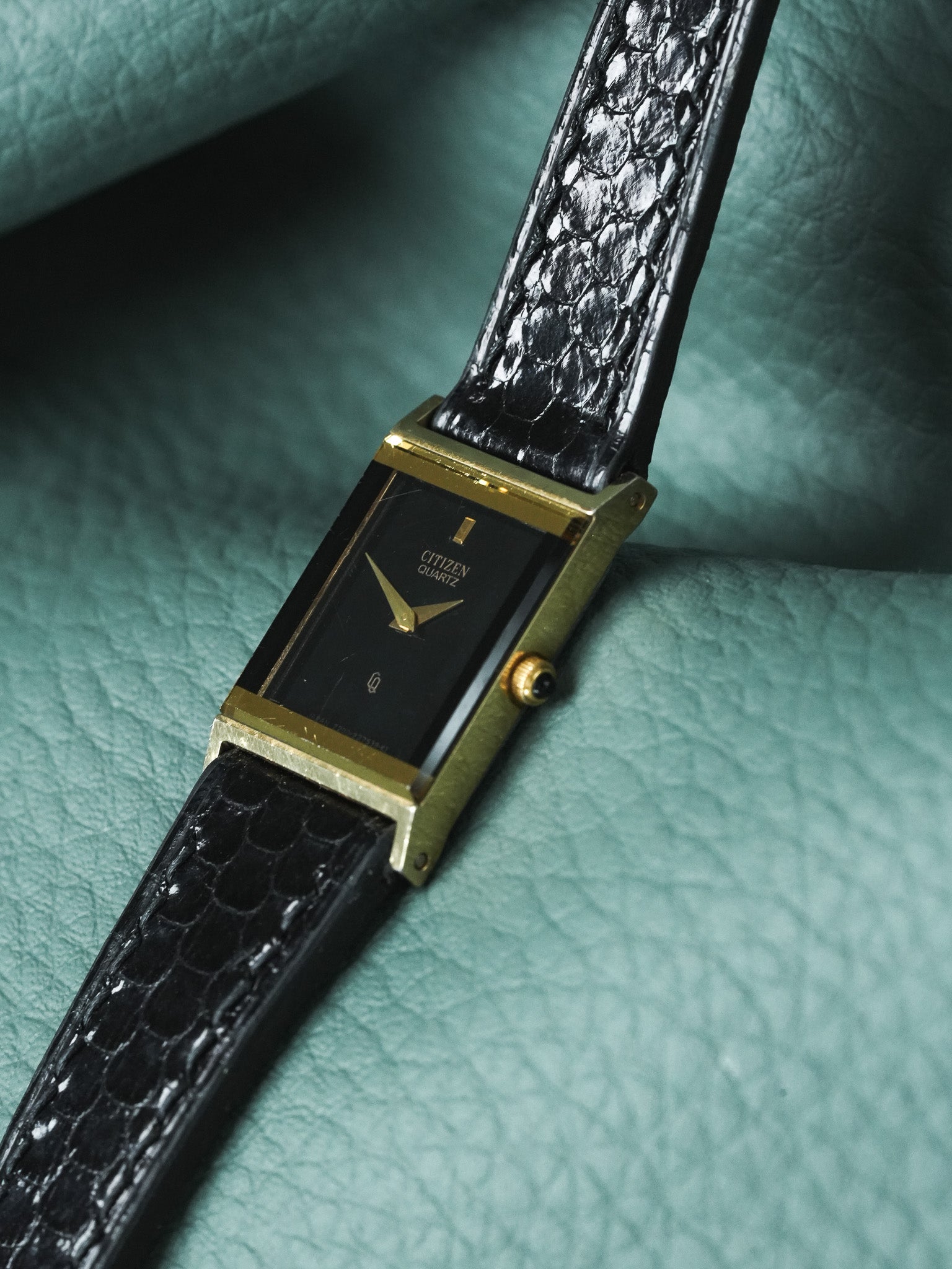 Citizen Quartz vintage watch with gold case, black dial, and textured leather strap