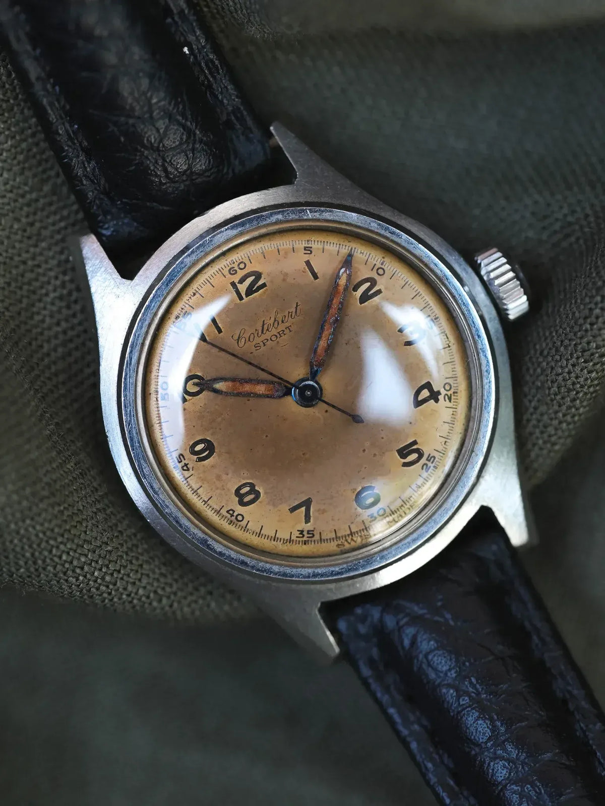 Cortébert Sport vintage watch with aged dial, steel case, black leather strap