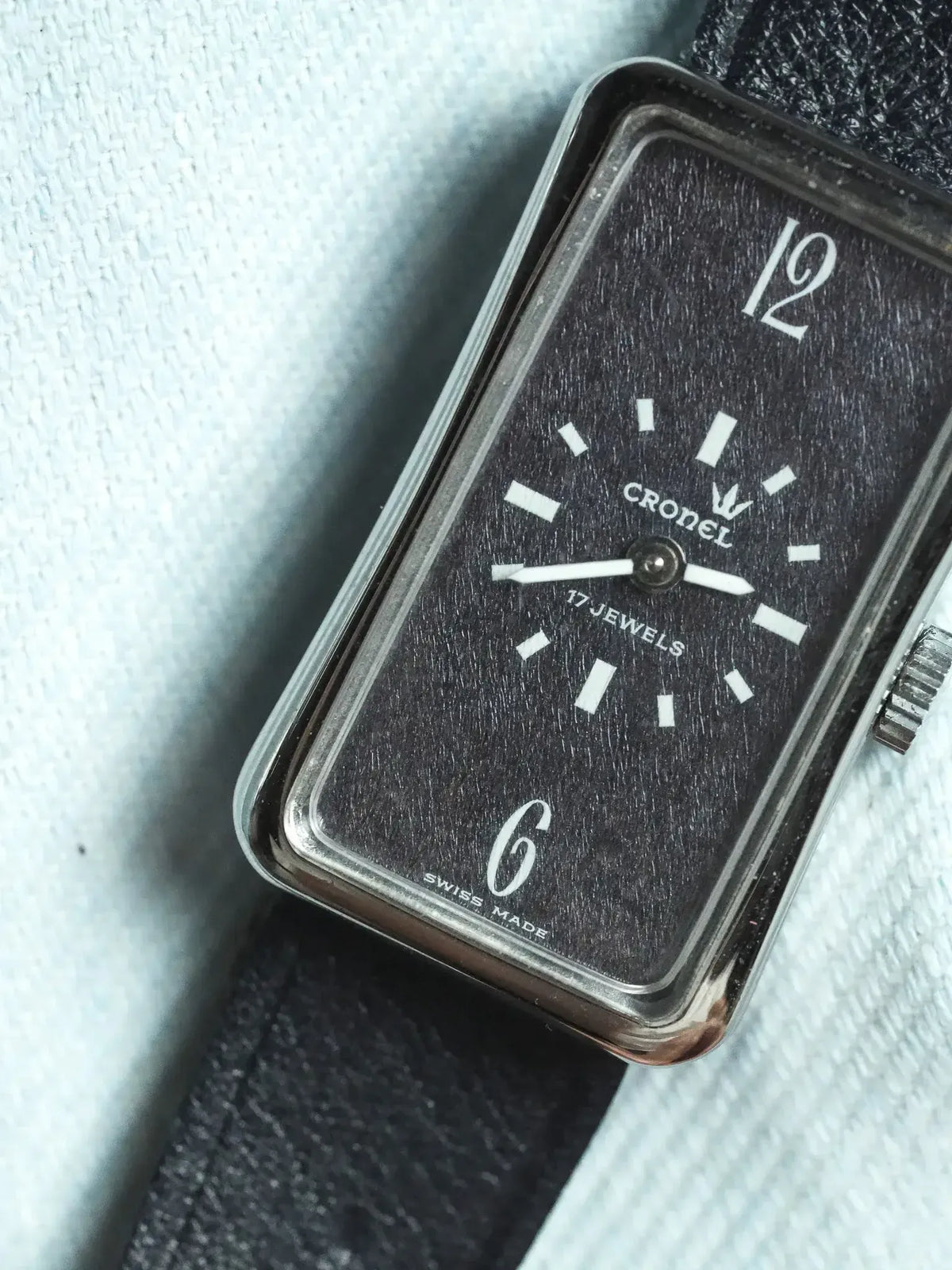 Cronel vintage watch with black textured dial, white markers, and steel case
