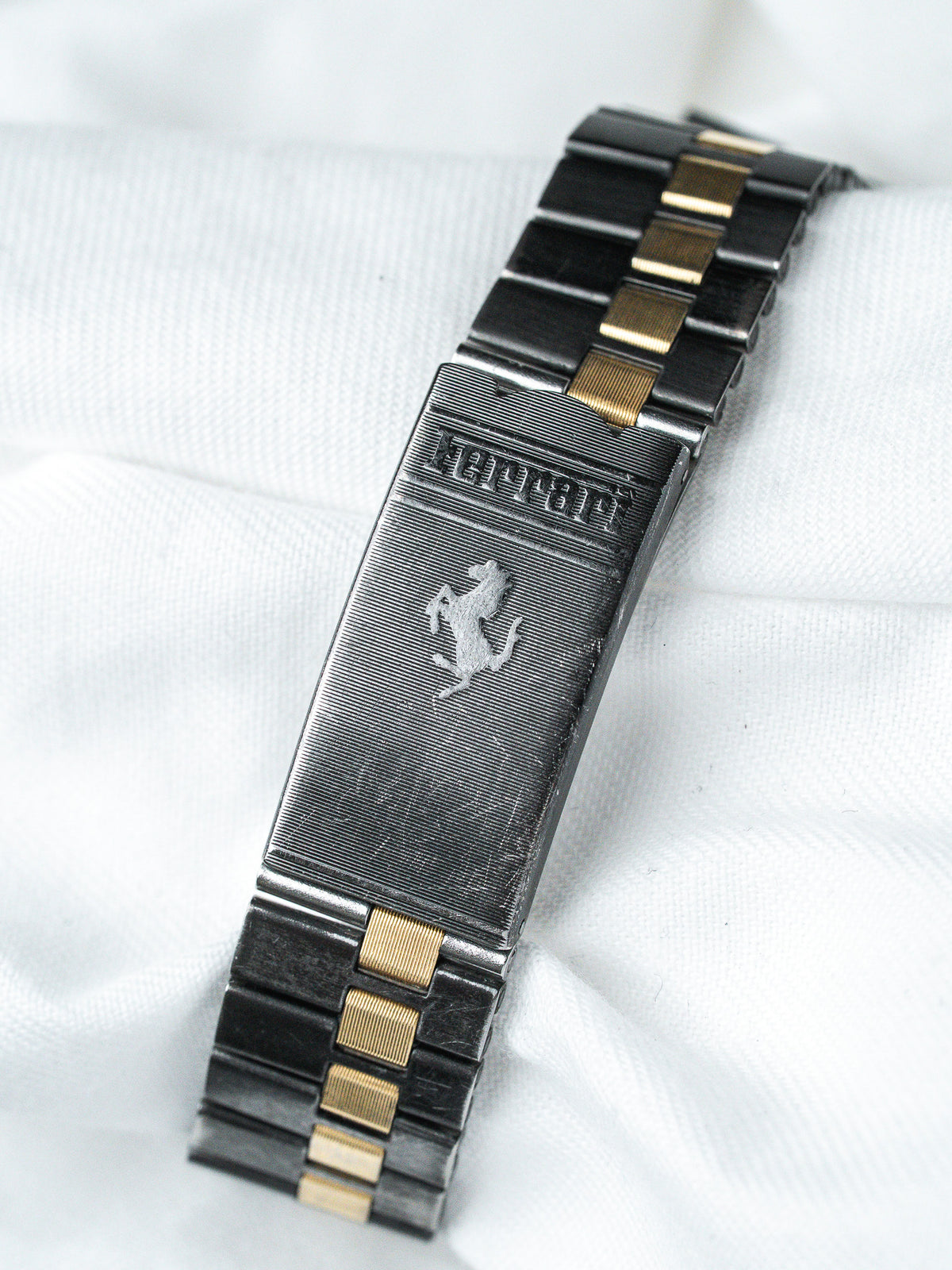Ferrari vintage bracelet with prancing horse emblem, black and gold links